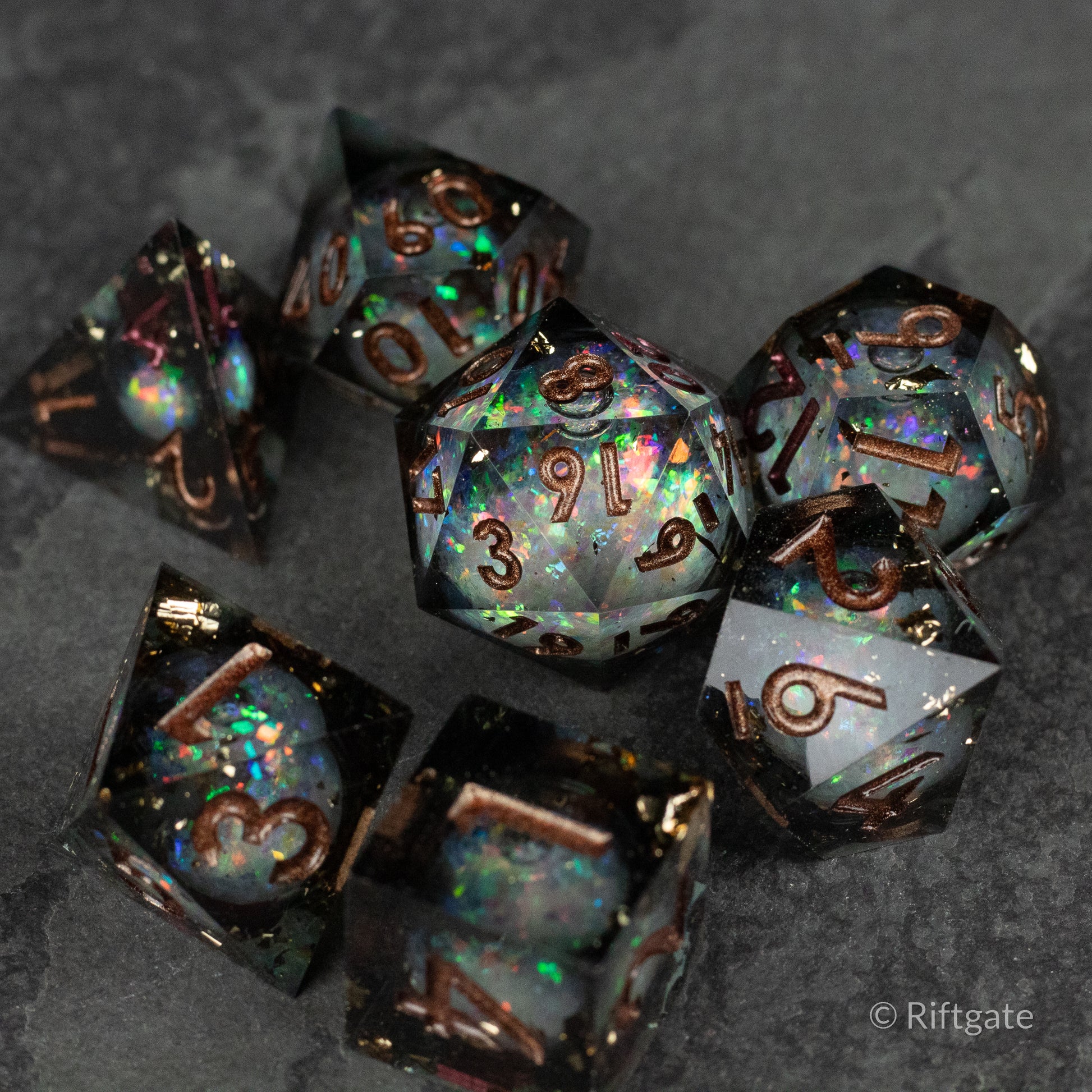 Wild Magic Liquid Core Dice Set - Set of seven black translucent polyhedral dice with iridescent, swirling liquid cores and metallic gold numbers, featuring.