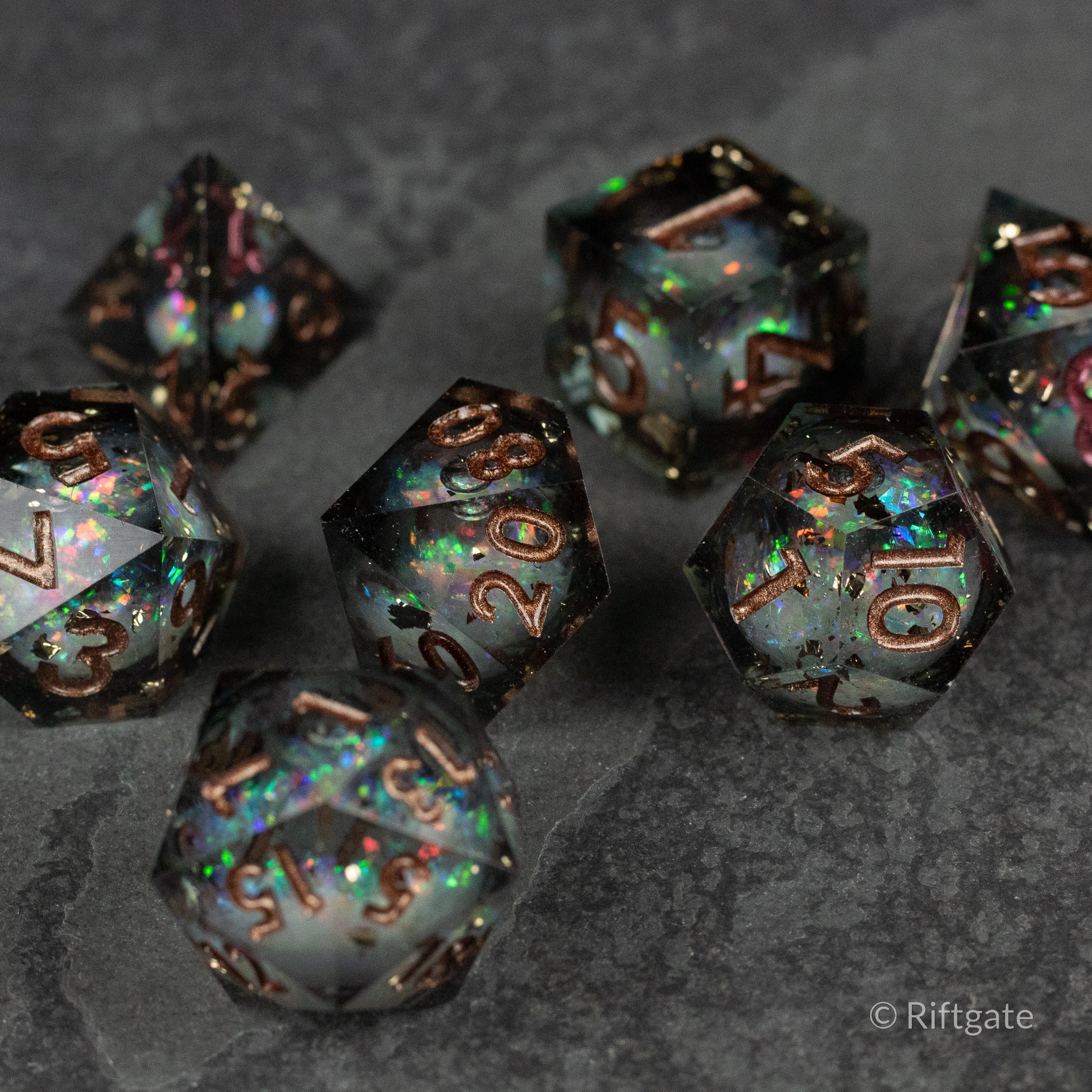 Wild Magic Liquid Core Dice Set - Black and iridescent sharp-edged polyhedral dice set with liquid core and bronze numbers.