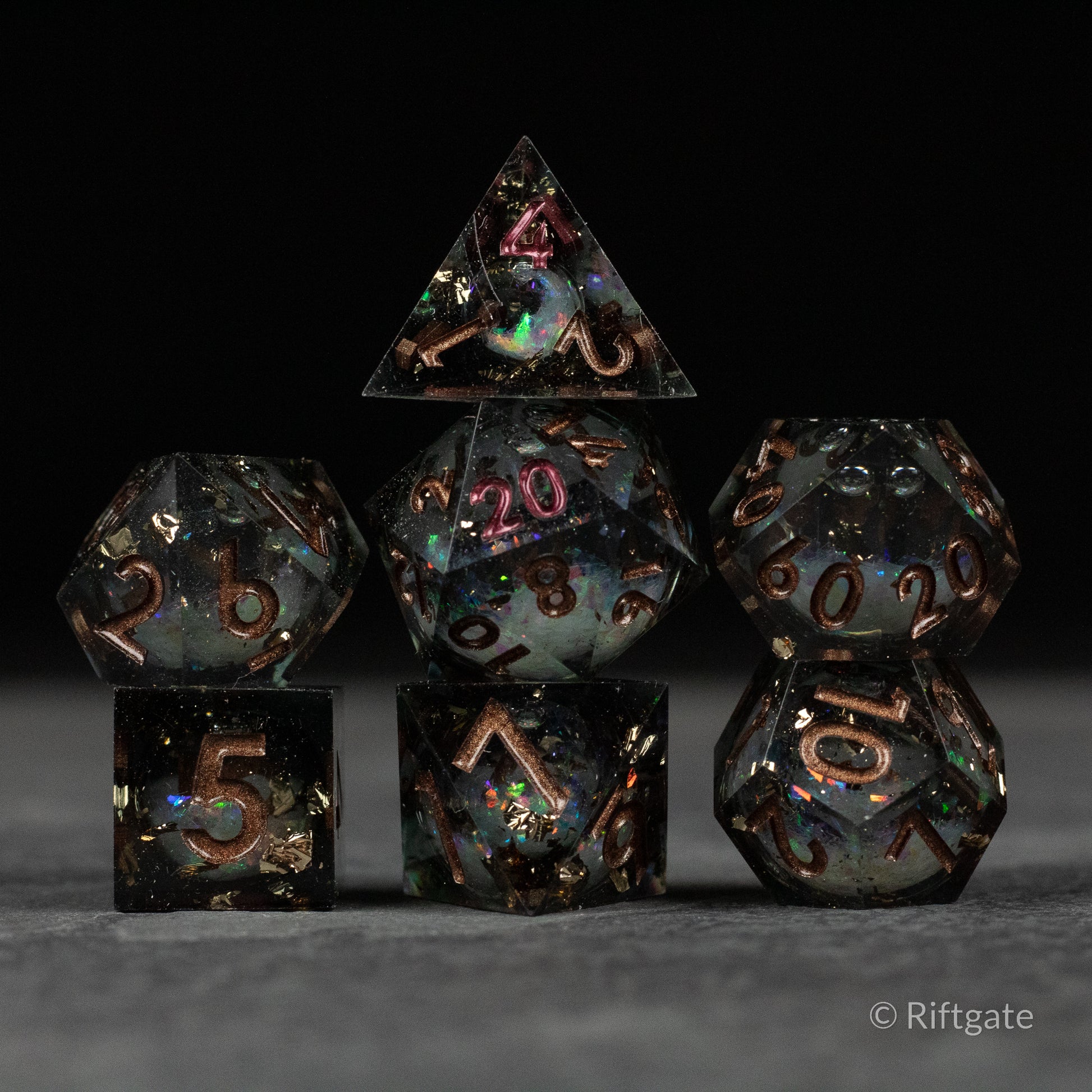 Wild Magic Liquid Core Dice Set - Seven-piece sharp-edged dice set with dark liquid core and gold numbering.