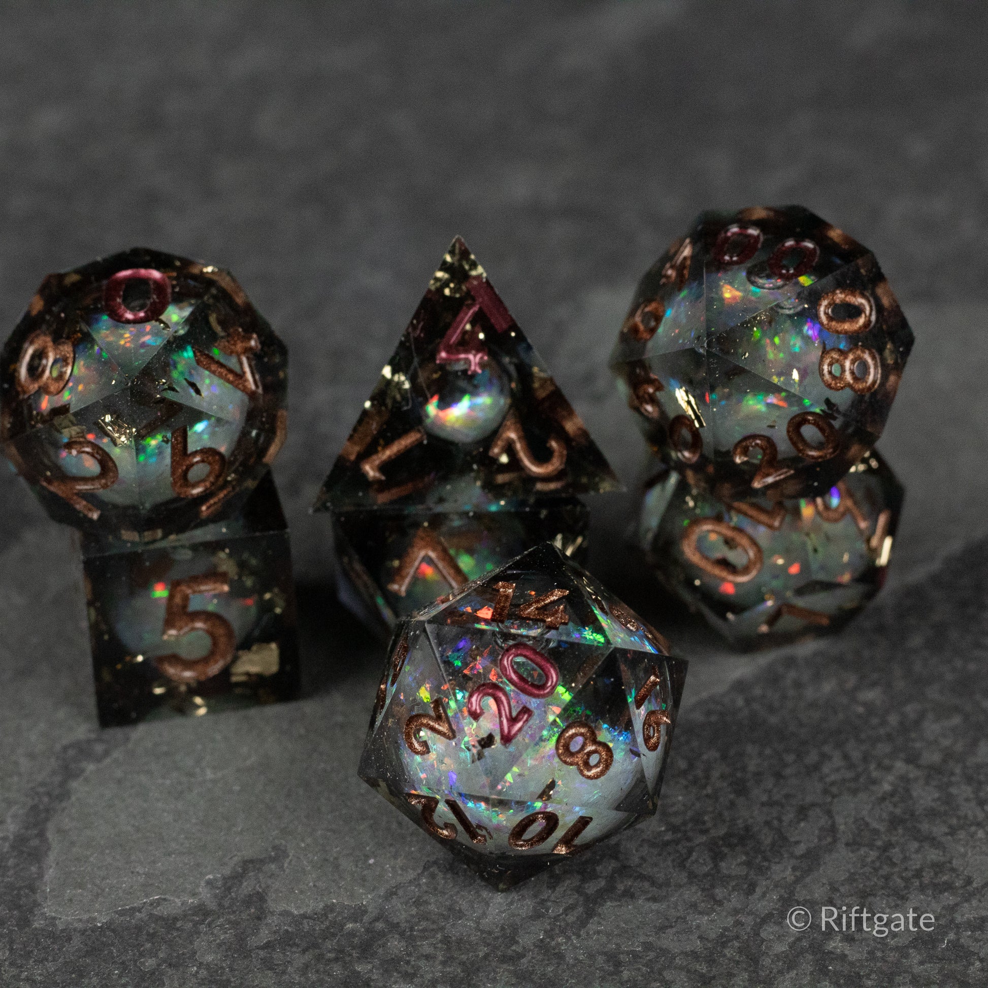 Wild Magic Liquid Core Dice Set - Set of six sharp-edged polyhedral dice with iridescent liquid cores and black translucent frames with copper numbers.