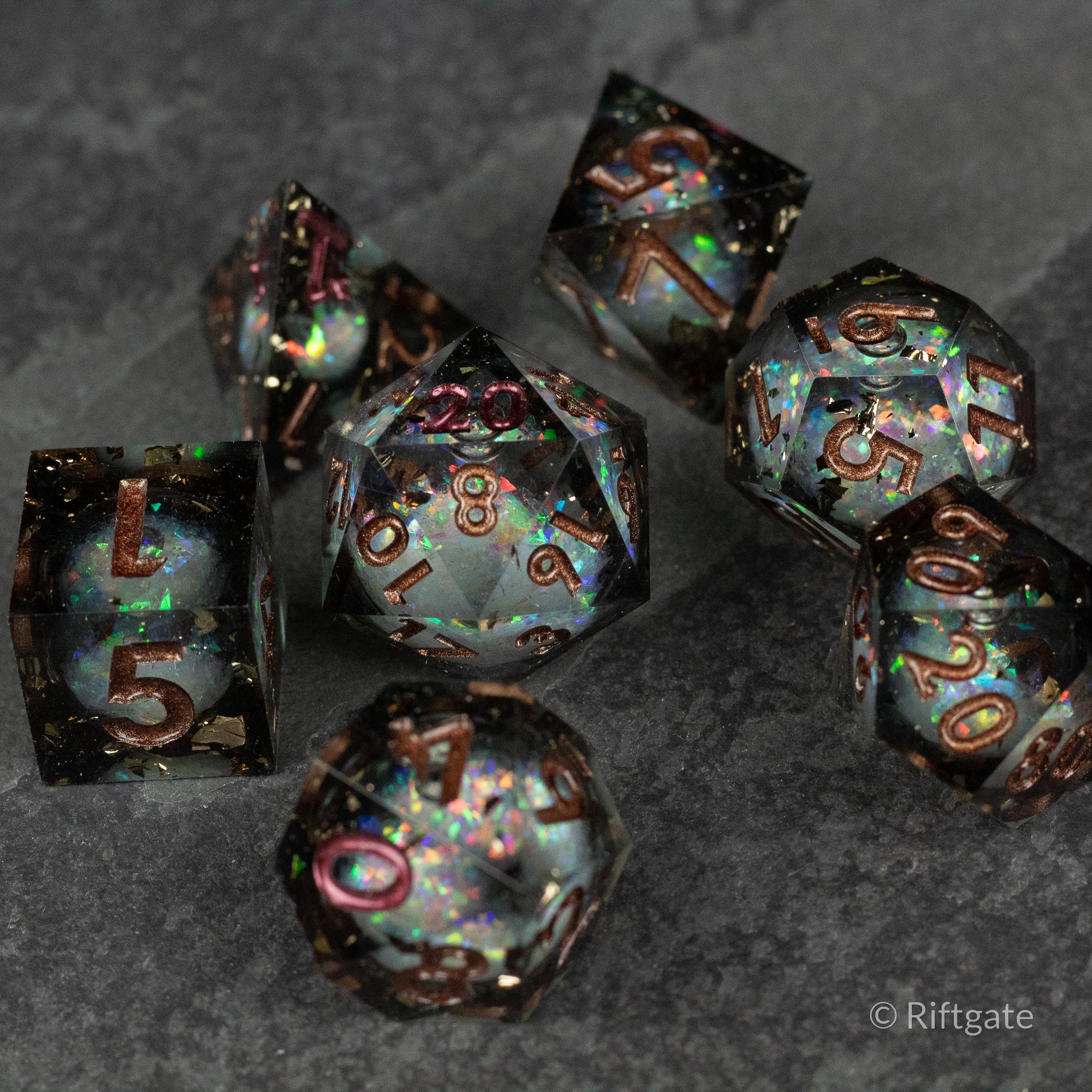 Wild Magic Liquid Core Dice Set - Seven translucent polyhedral dice with sharp edges, iridescent colors, and gold numbering.