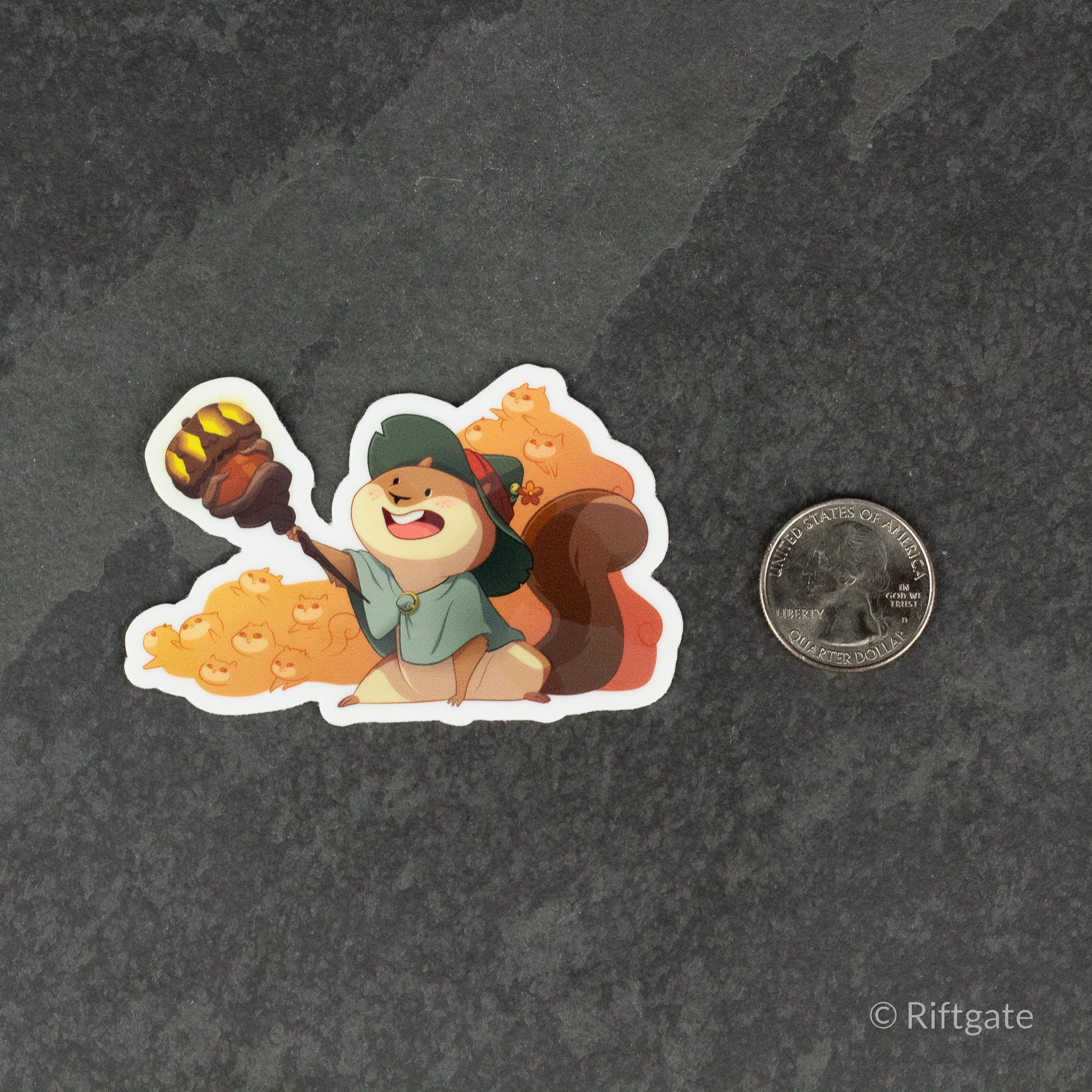 Squirrelmancer Sticker - Colorful cartoon squirrel wearing a green wizard hat and cloak, holding a glowing staff, sitting next to a pile of acorns.