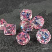 Blue Star Pink Glitter Dice - Set of translucent polyhedral dice with blue star inclusions and pink glitter, pink numbers visible on each face.