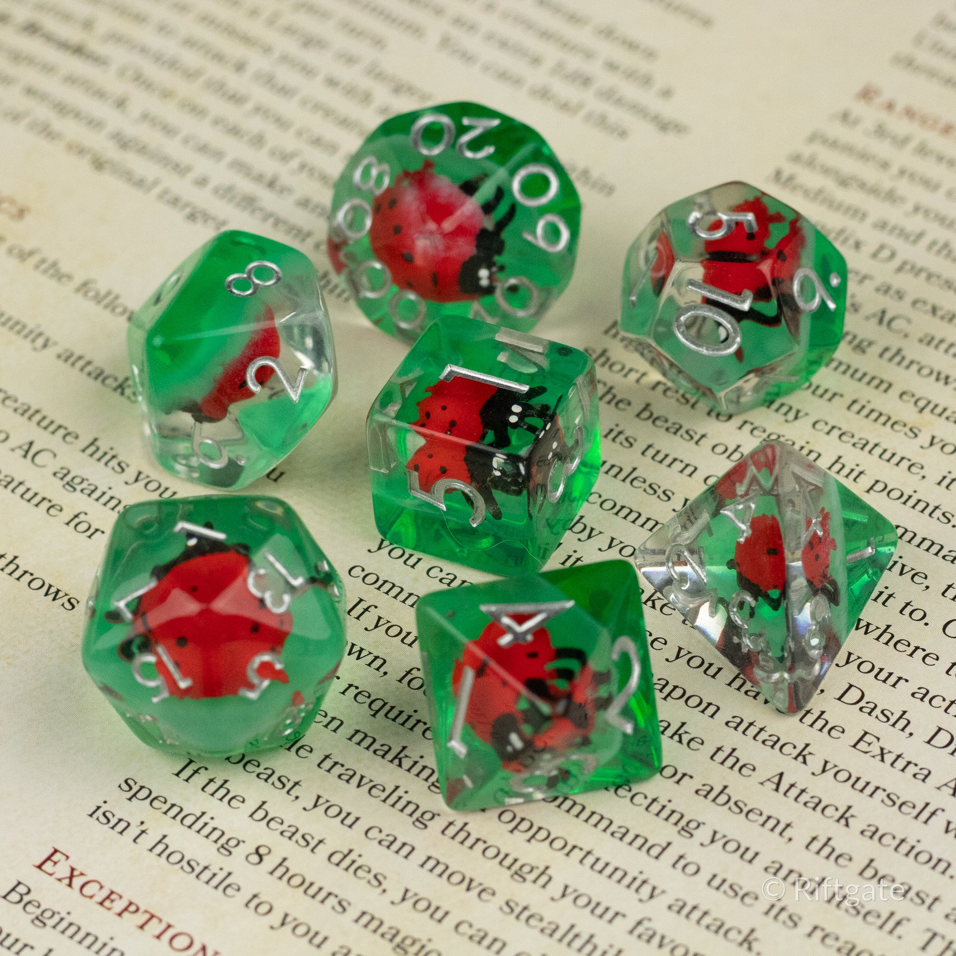 Ladybug Dice Set - Type 2 - Green transparent polyhedral dice set with red and black ladybug figurines inside and white numbering.