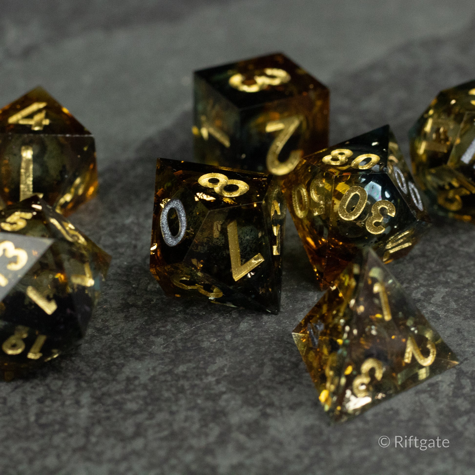 Ambershadow Dice Set - Translucent amber polyhedral dice set with gold numbers and a shimmering liquid core.