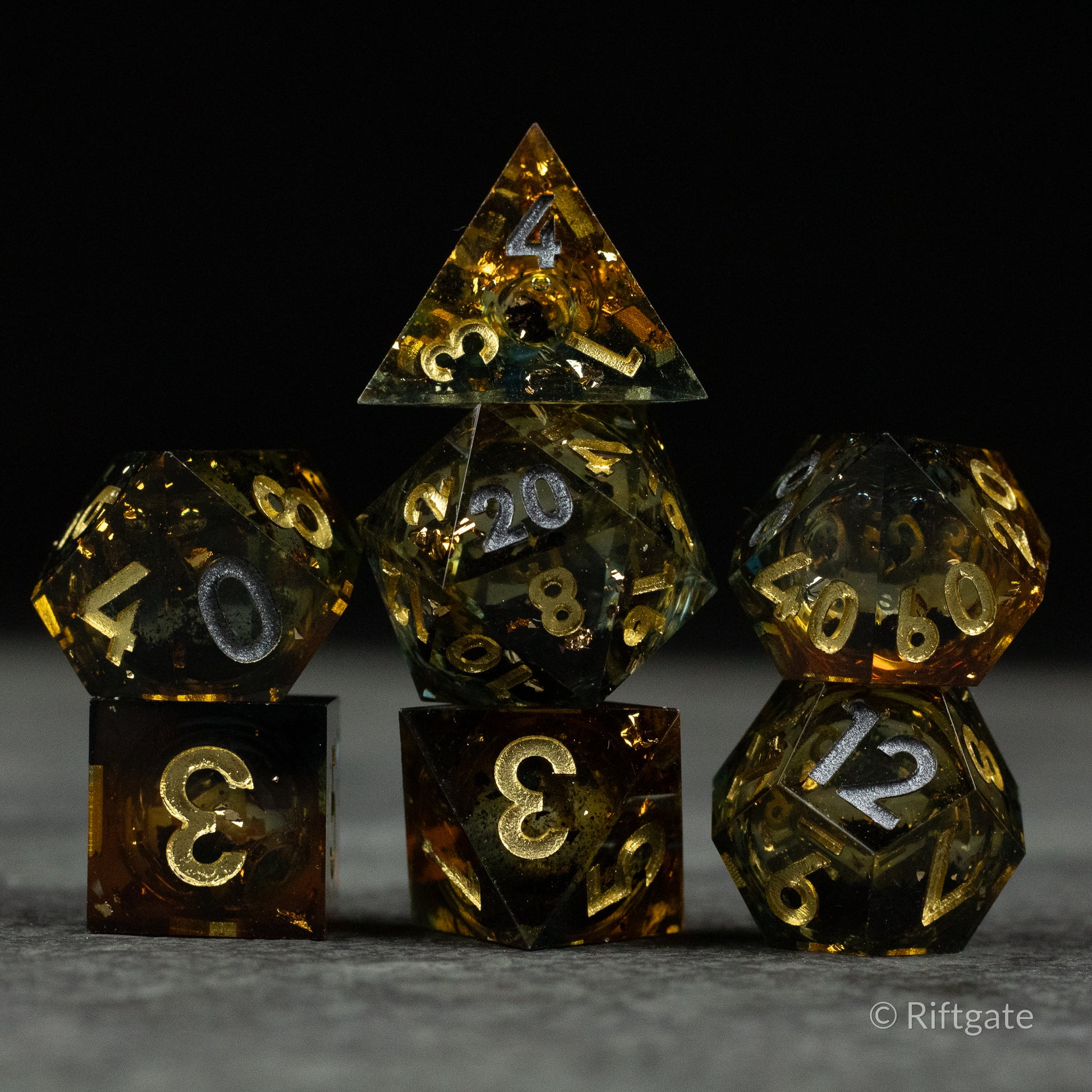 Ambershadow Dice Set - Seven-piece translucent ambershadow dice set with gold and white numbering, featuring a mix of polyhedral shapes.