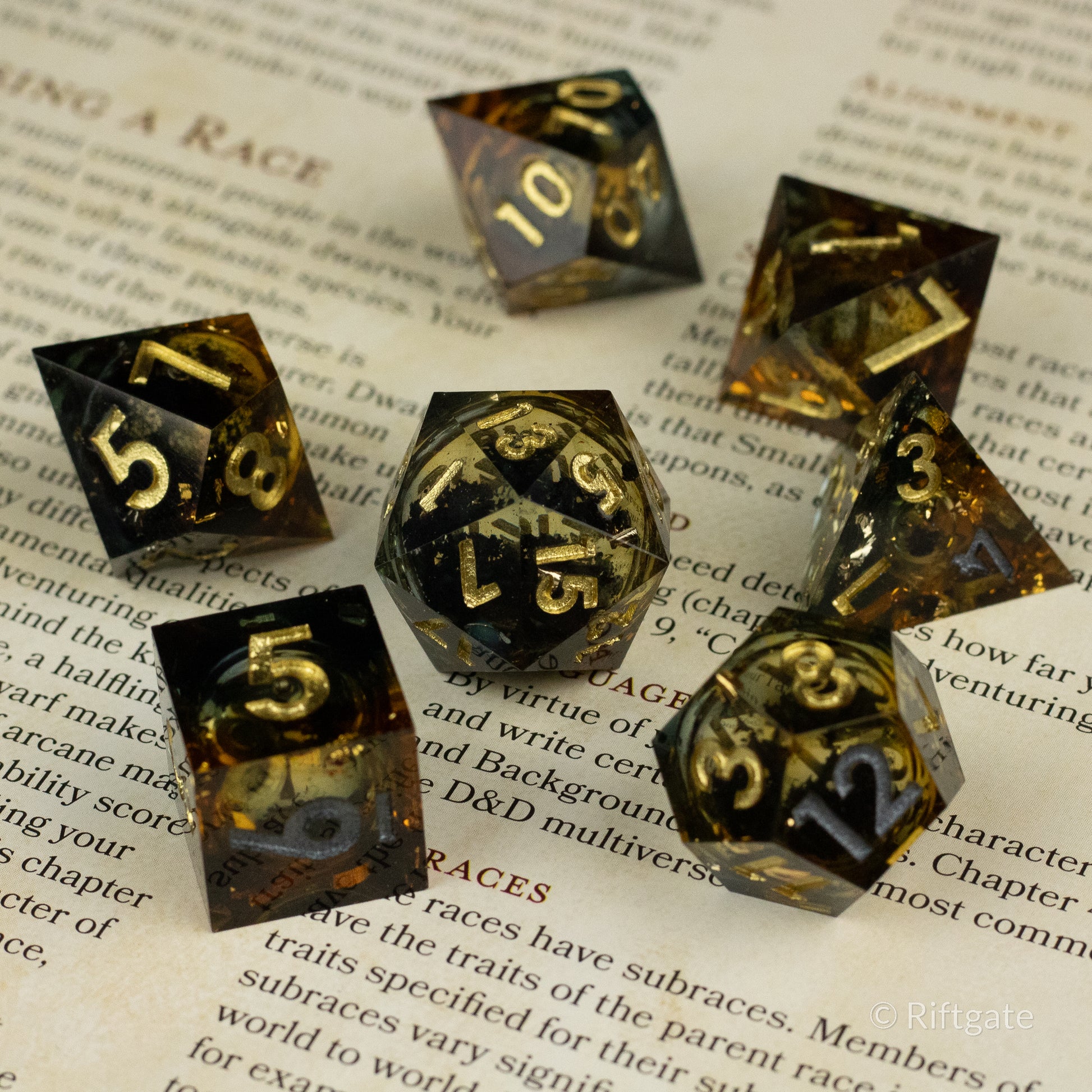 Ambershadow Dice Set - Set of seven polyhedral dice with black and amber liquid core, gold numbering, glossy finish.