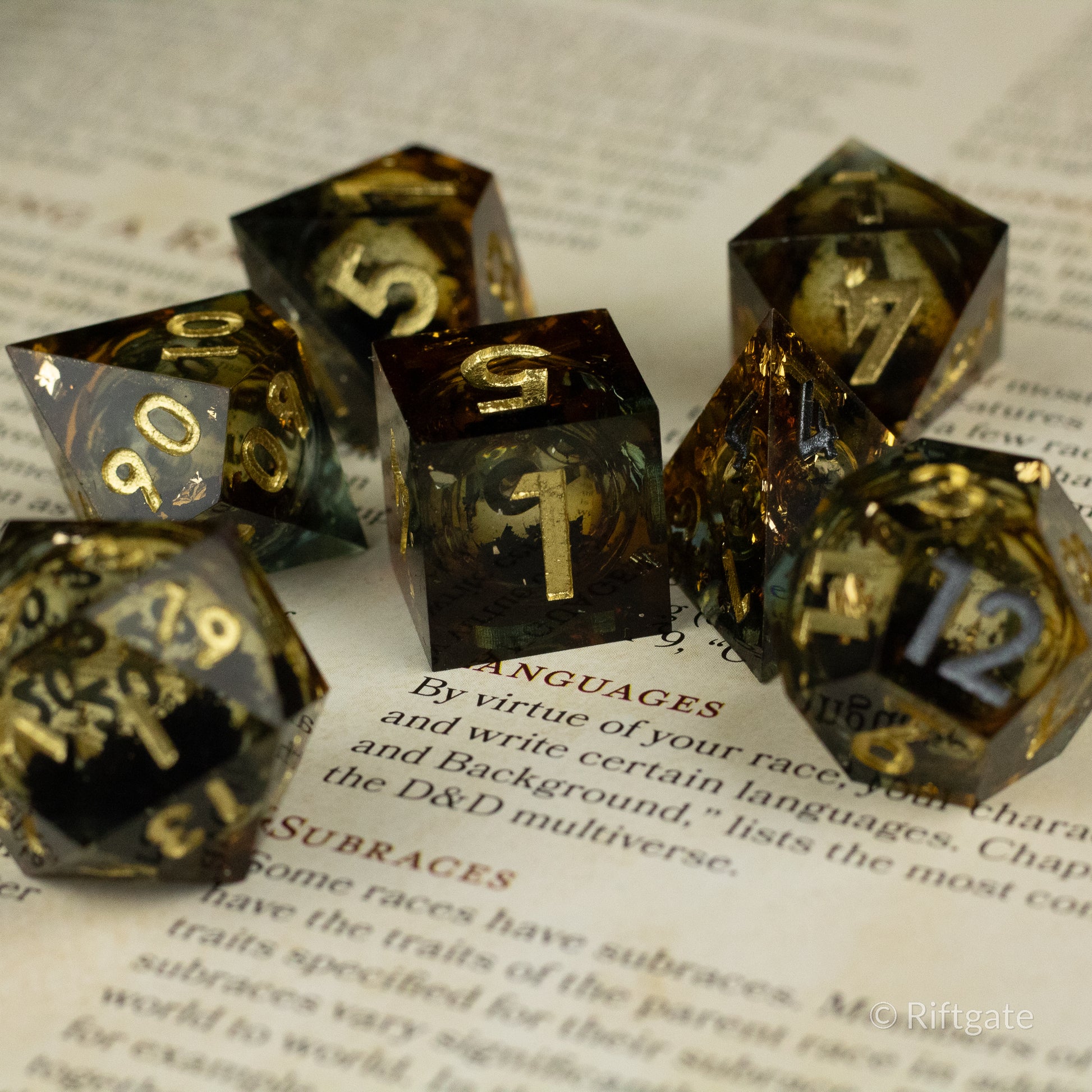 Ambershadow Dice Set - Seven dark translucent polyhedral dice with swirling amber liquid core and gold numbering.