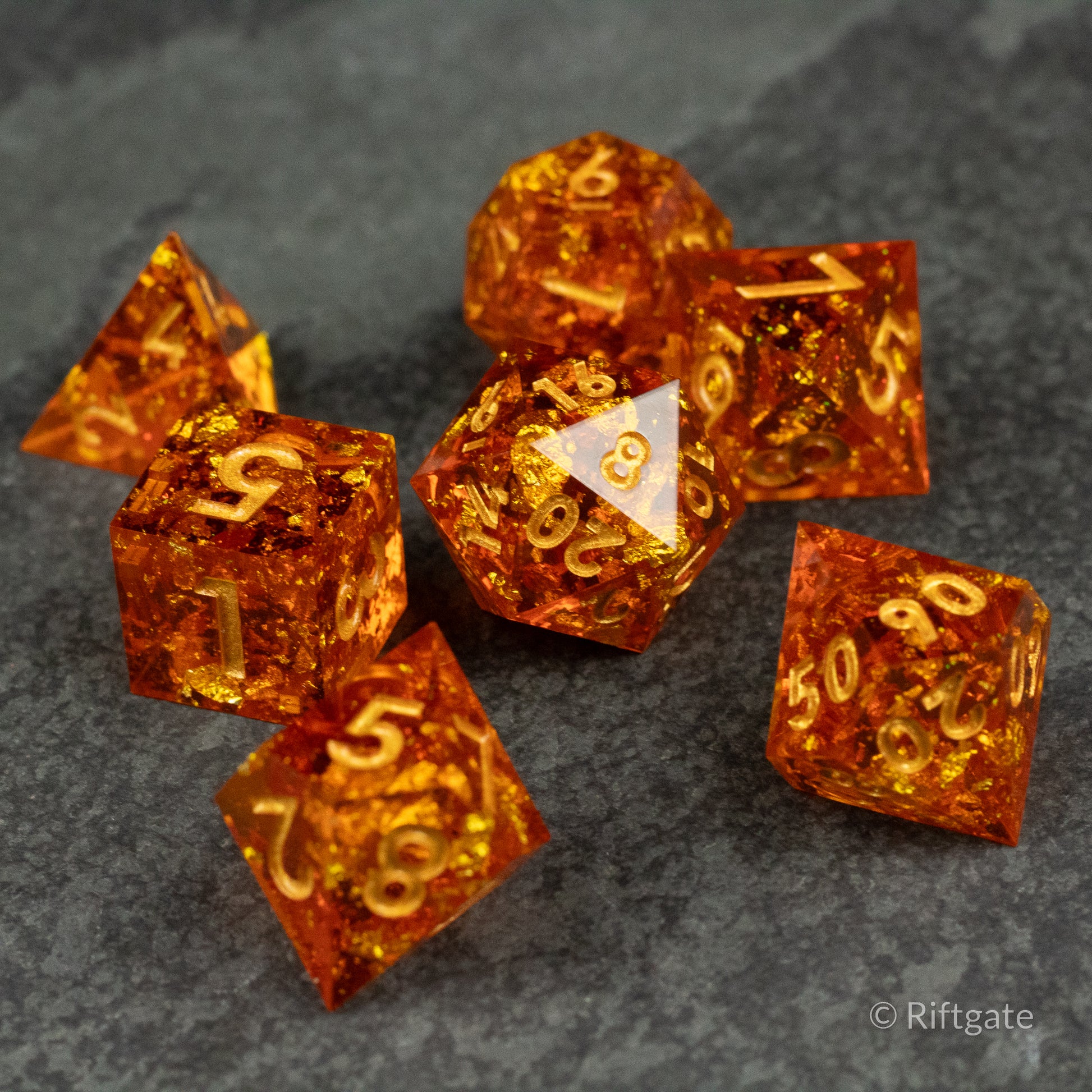 Sunforged Dice Set - Seven translucent amber-orange polyhedral dice with gold numbering and sharp edges on a dark textured surface.
