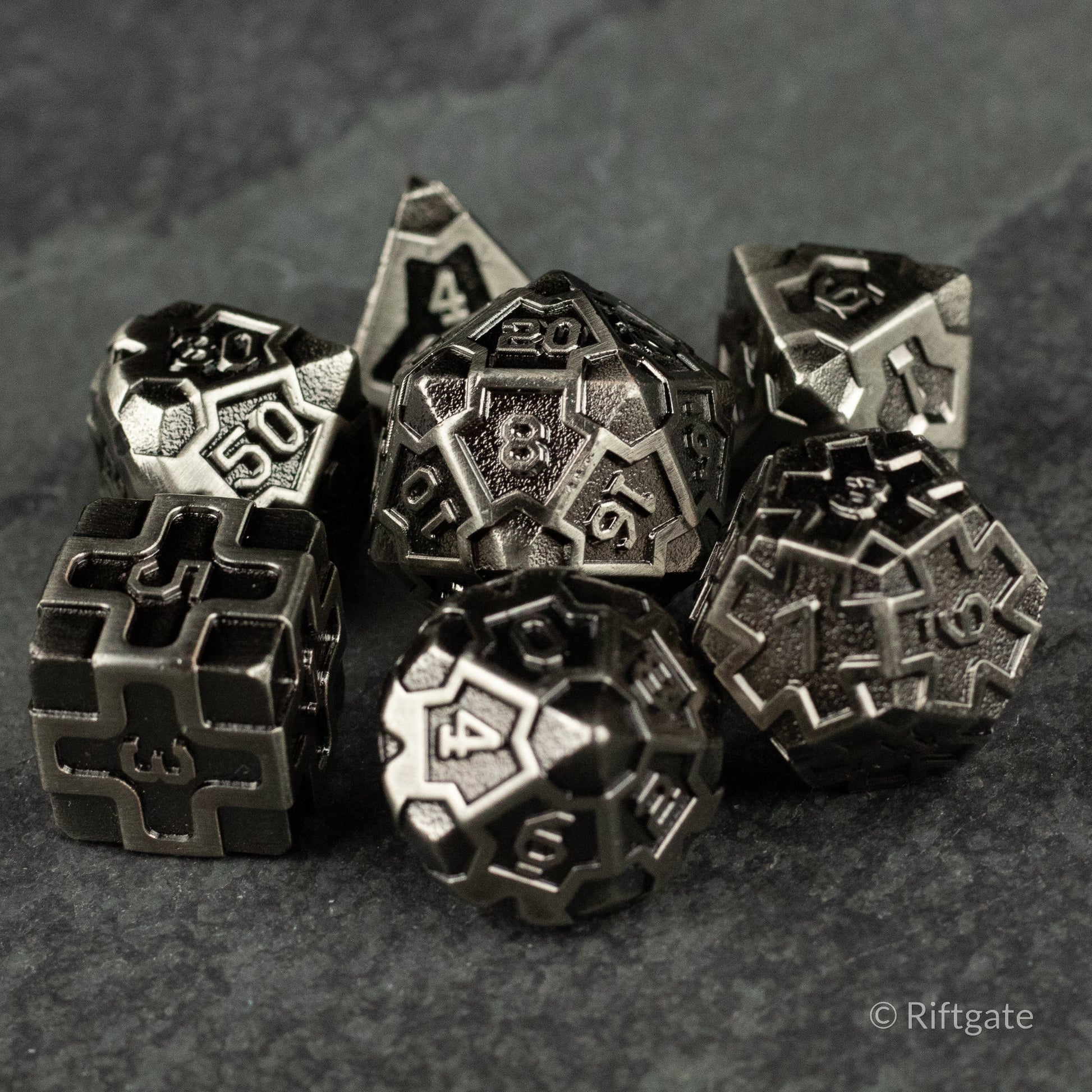 Iron Crusader - Metallic black polyhedral dice set with intricate geometric engravings and silver numbering.
