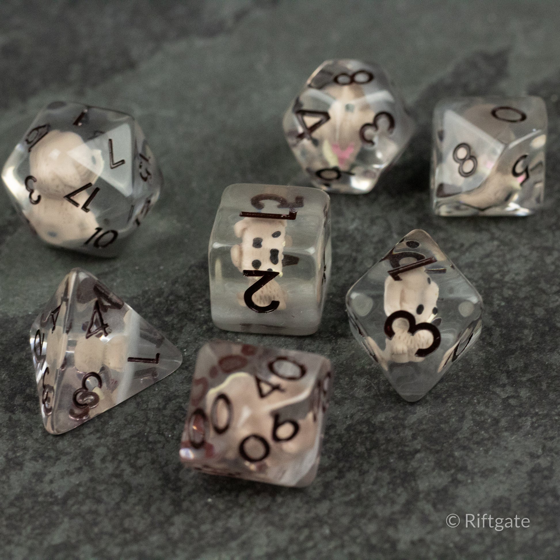 Scruffy Dog Dice - Set of seven translucent polyhedral dice with black numbers, each containing a small white dog figurine inside.