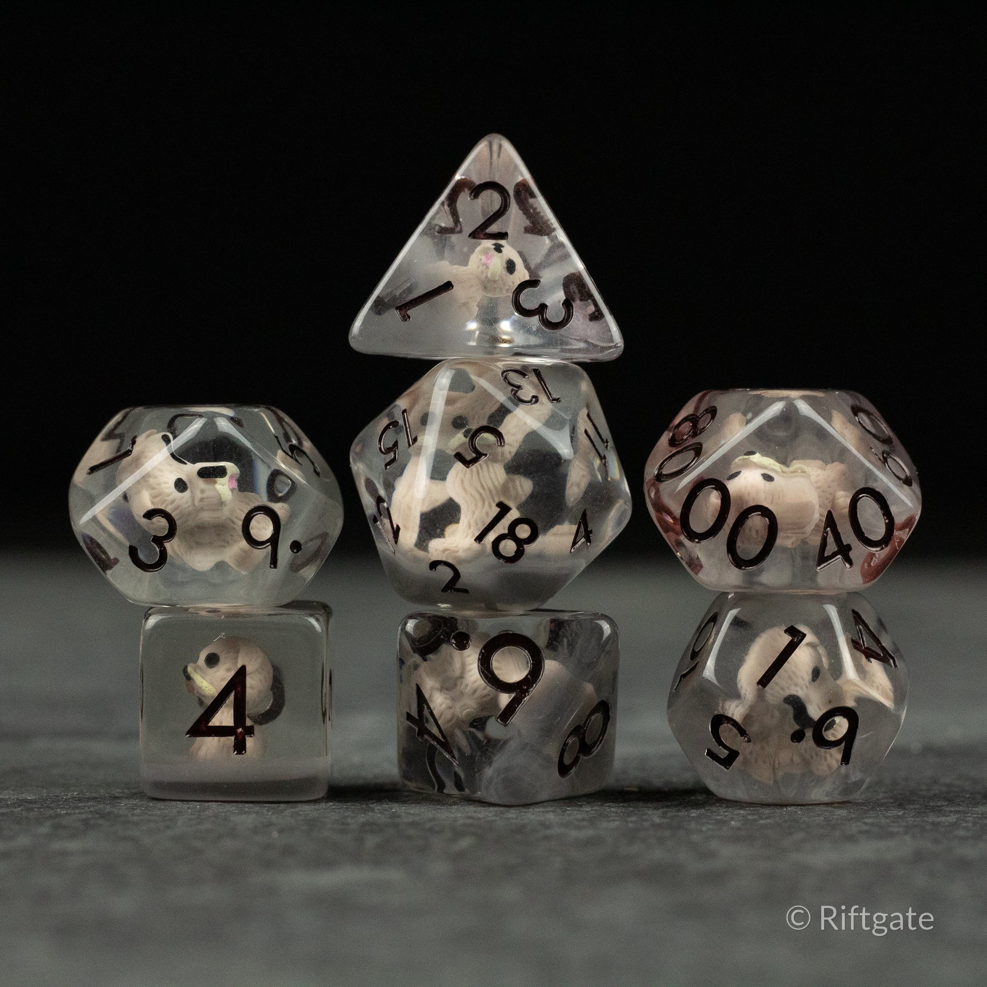 Scruffy Dog Dice - Set of seven translucent polyhedral dice with black numbers and swirling gray and white patterns inside.