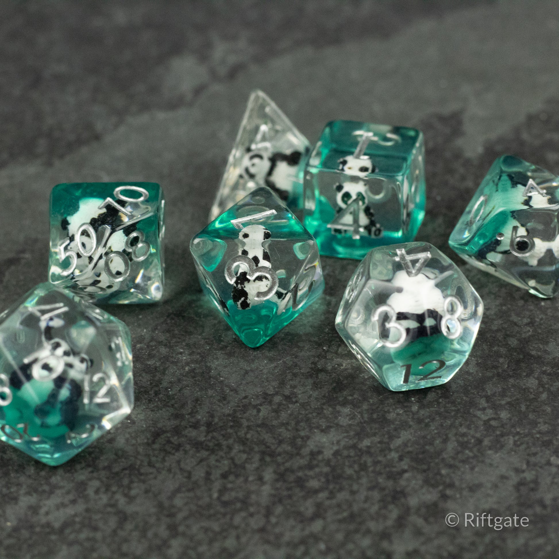 Panda Dice Set - Set of translucent teal polyhedral dice featuring black and white panda face designs on each side.