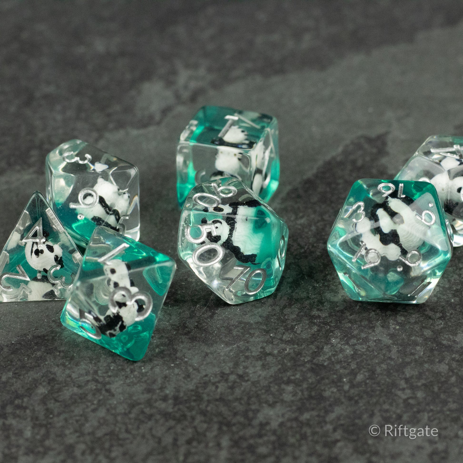 Panda Dice Set - Transparent teal and clear polyhedral dice set with black and white panda designs inside, including a d4, d6, d8, d10, d12,.