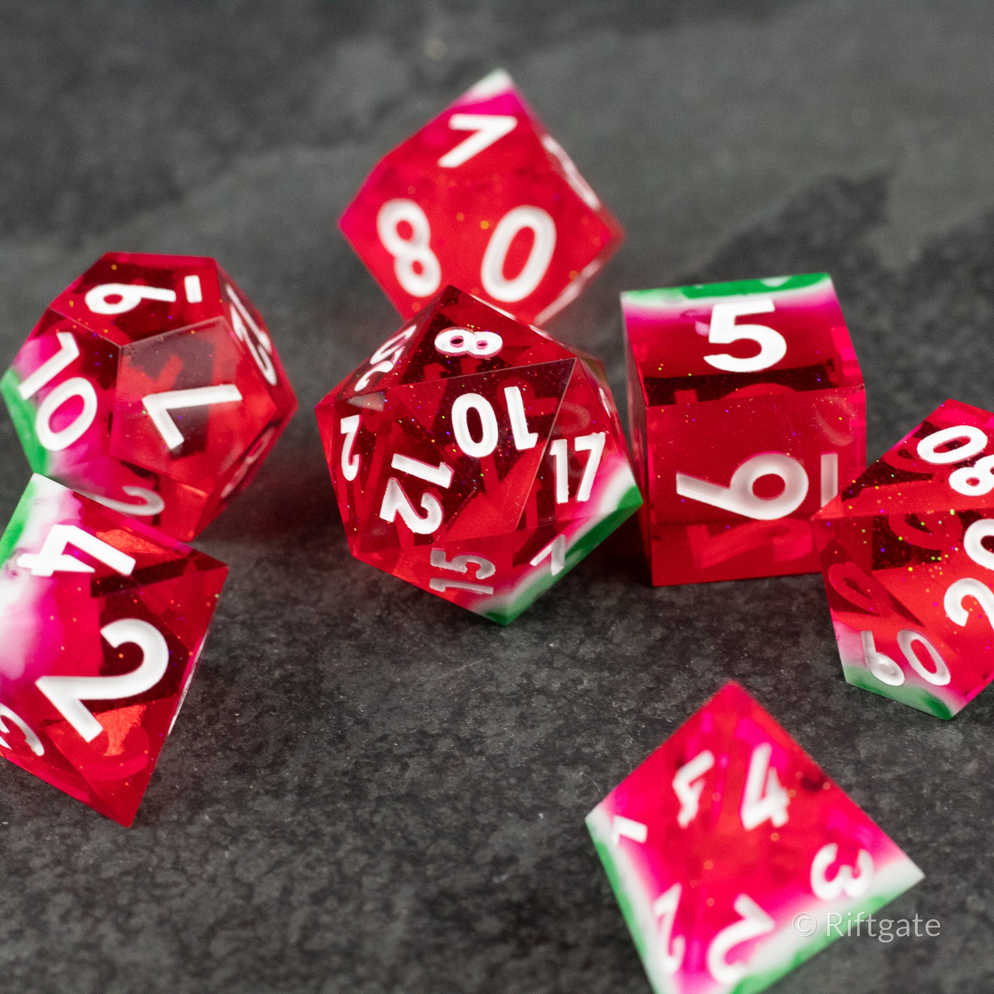 Watermelon Sharp Edge Dice - Set of sharp edge polyhedral dice in translucent red with green and white accents, white numbering.