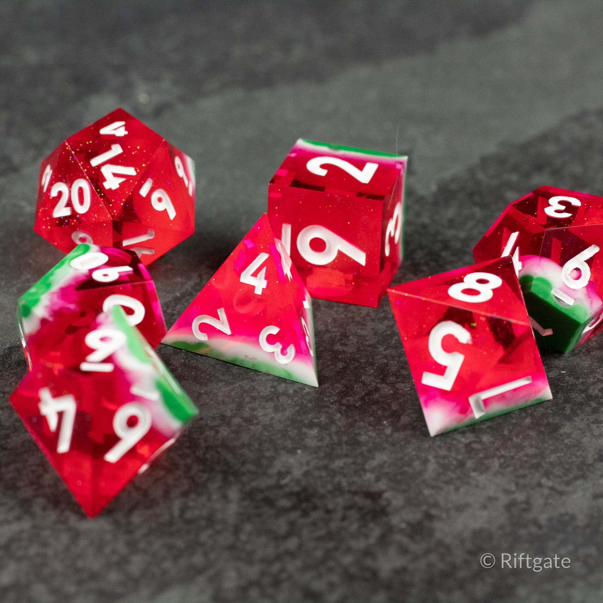 Watermelon Sharp Edge Dice - Set of six translucent dice designed to look like watermelon slices with red bodies, white numbers, and green rinds on.