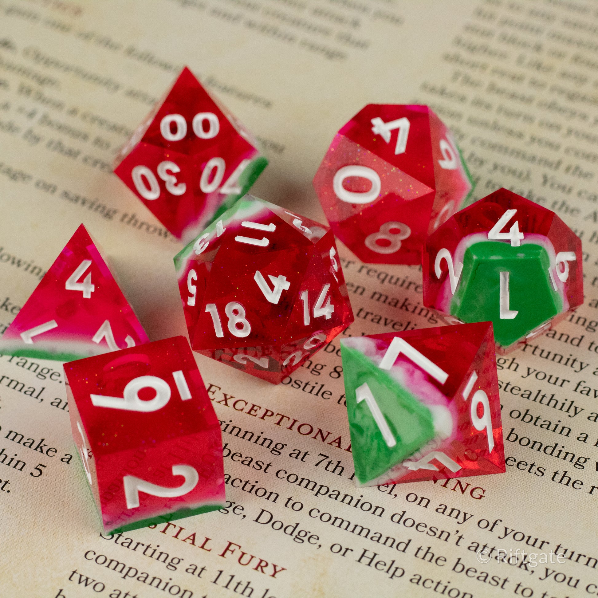 Watermelon Sharp Edge Dice - Set of transparent red and green sharp edge dice with white numbers, resembling watermelon colors.