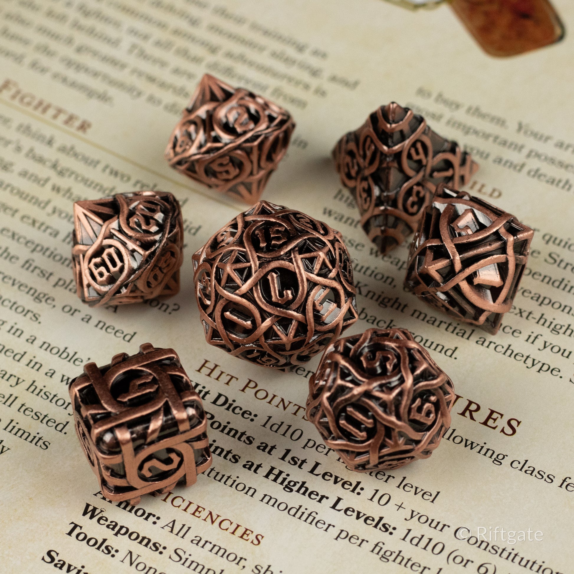 Runeweave Metal Dice Set - Copper-colored metal polyhedral dice set with intricate rune-like engravings and a metallic finish.
