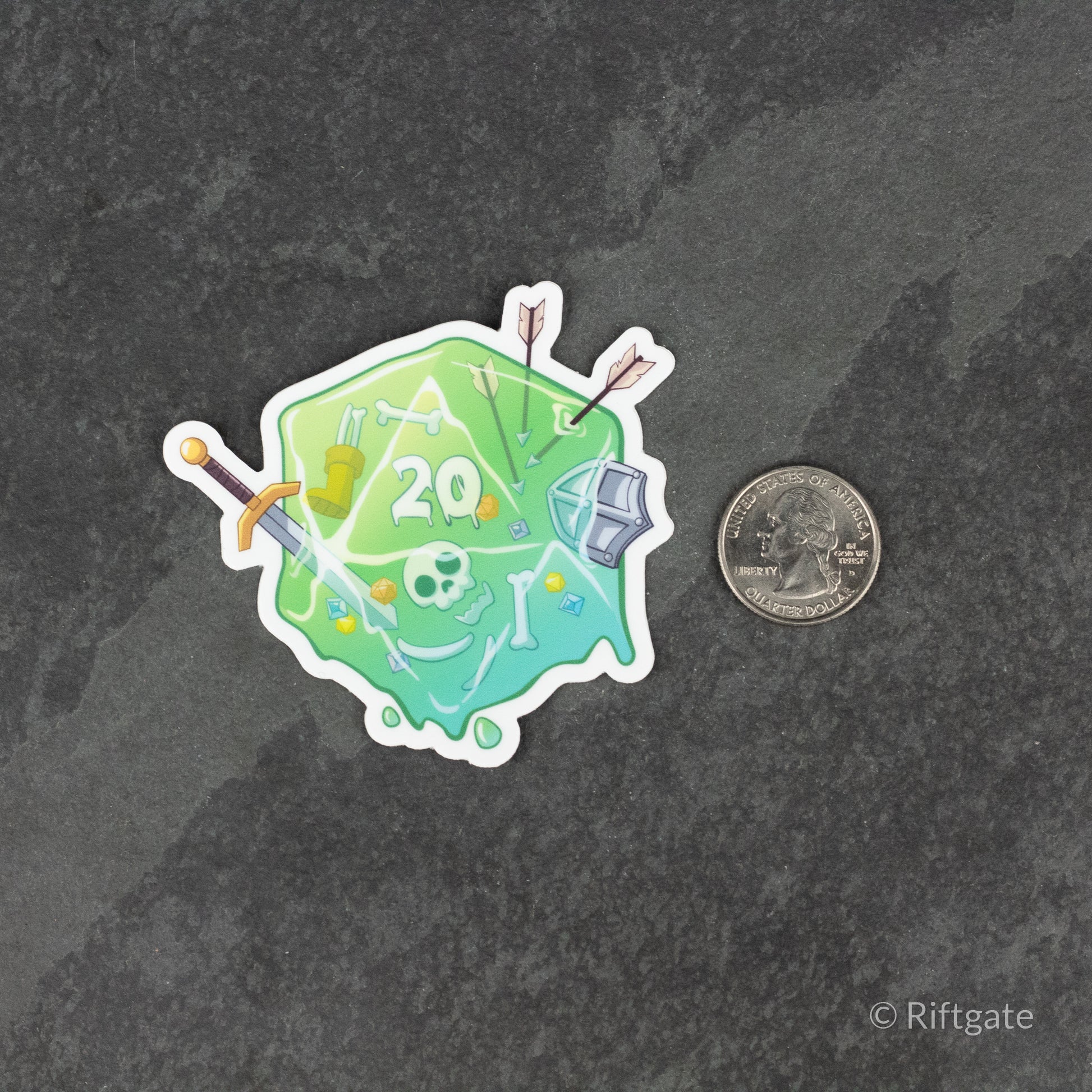 Gelatinous D20 DnD Sticker - Translucent green gelatinous d20 die sticker with embedded fantasy items like skull, sword, and arrows next to a quarter for
