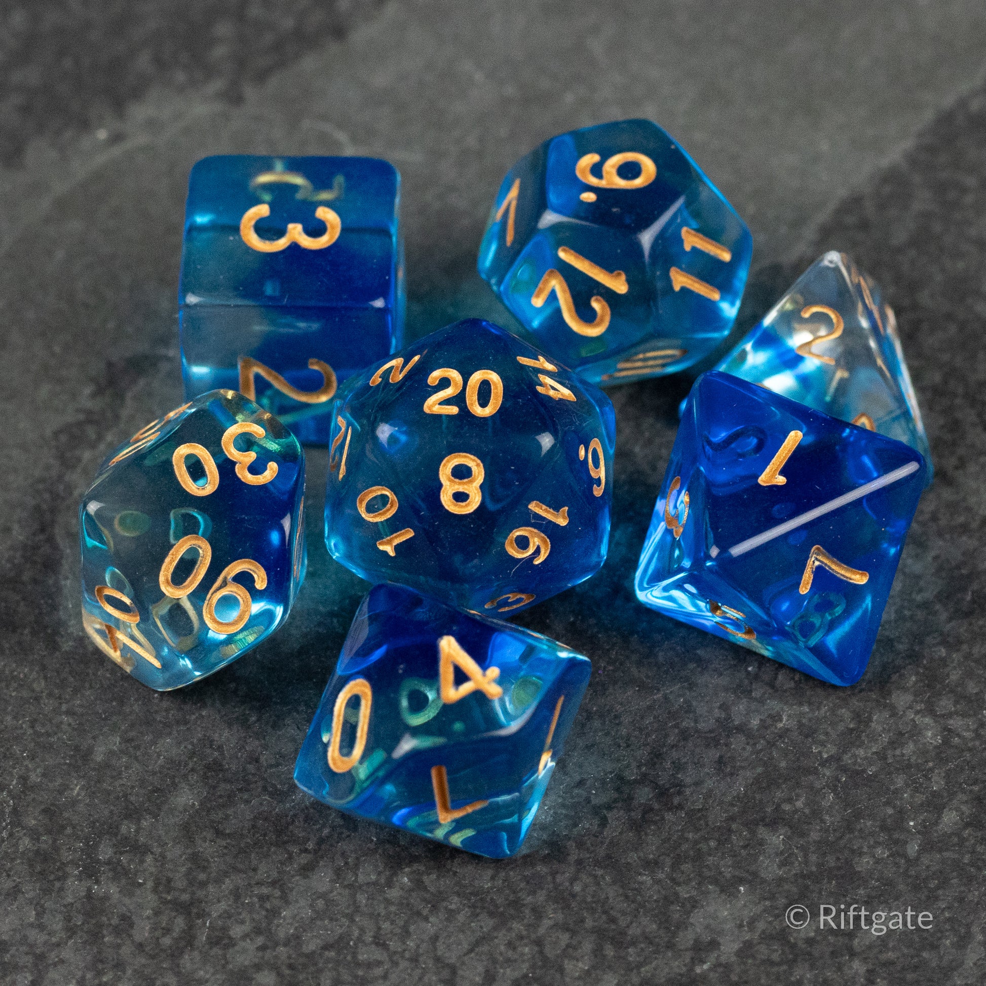 Ethereal Mist Dice Set - Translucent blue polyhedral dice set with gold numbers, featuring d4, d6, d8, d10, d12, and d20 shapes.