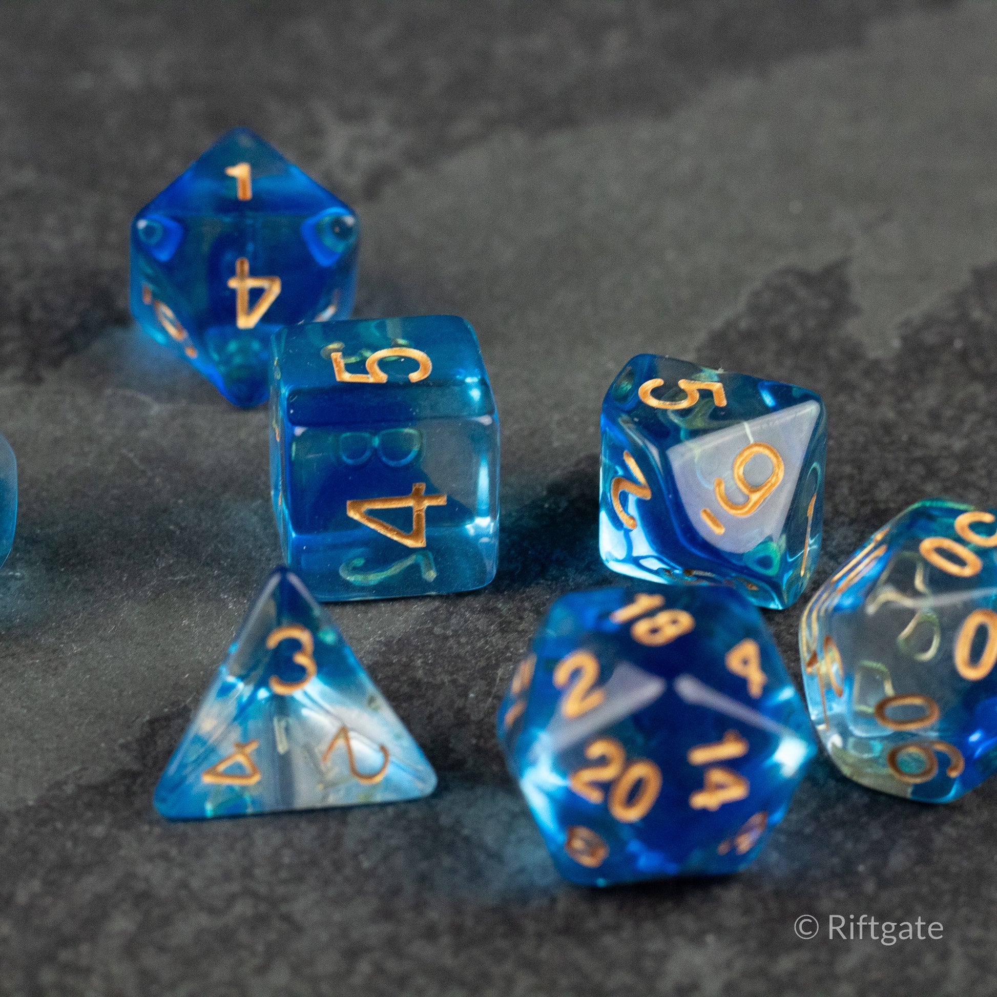 Ethereal Mist Dice Set - Blue translucent polyhedral dice set with gold numbering, including d4, d6, d8, d10, d12, and d20 shapes.