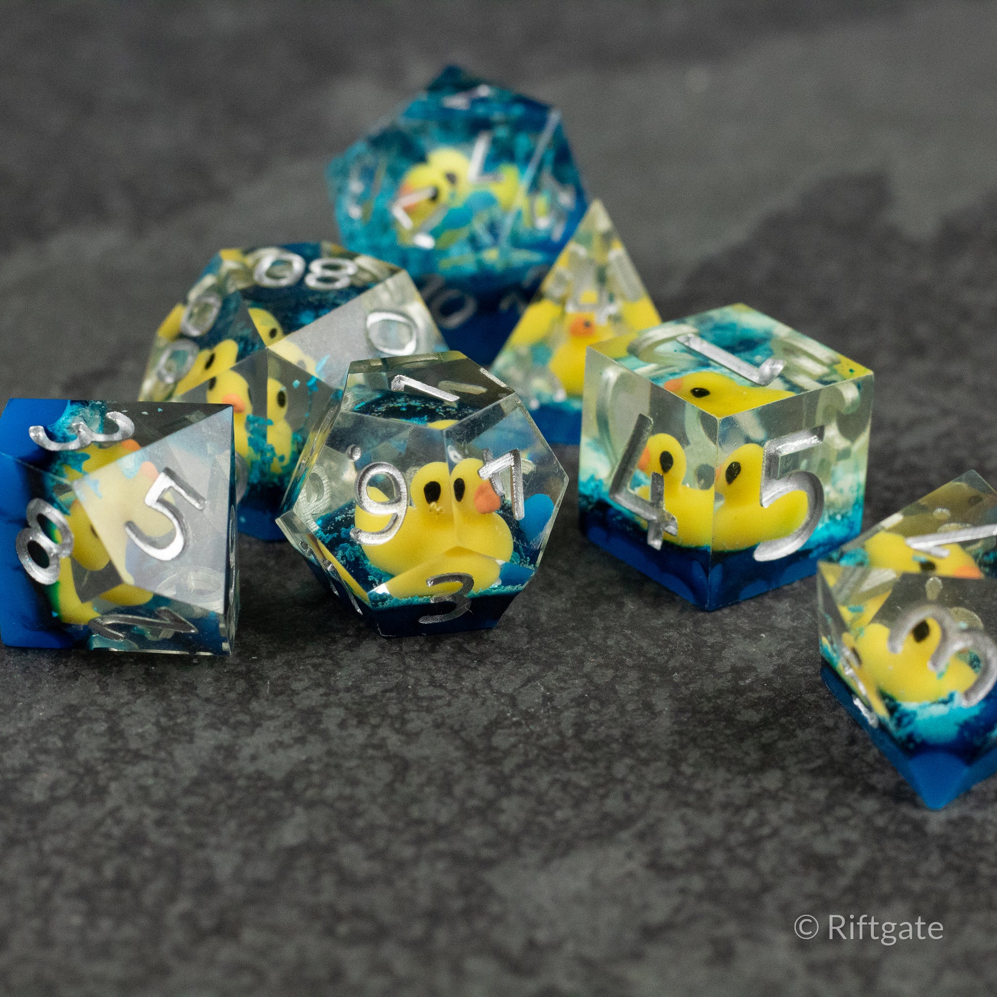 Rubber Duck Sharp Edge Dice - Set of translucent sharp edge dice with embedded yellow rubber duck figures inside.