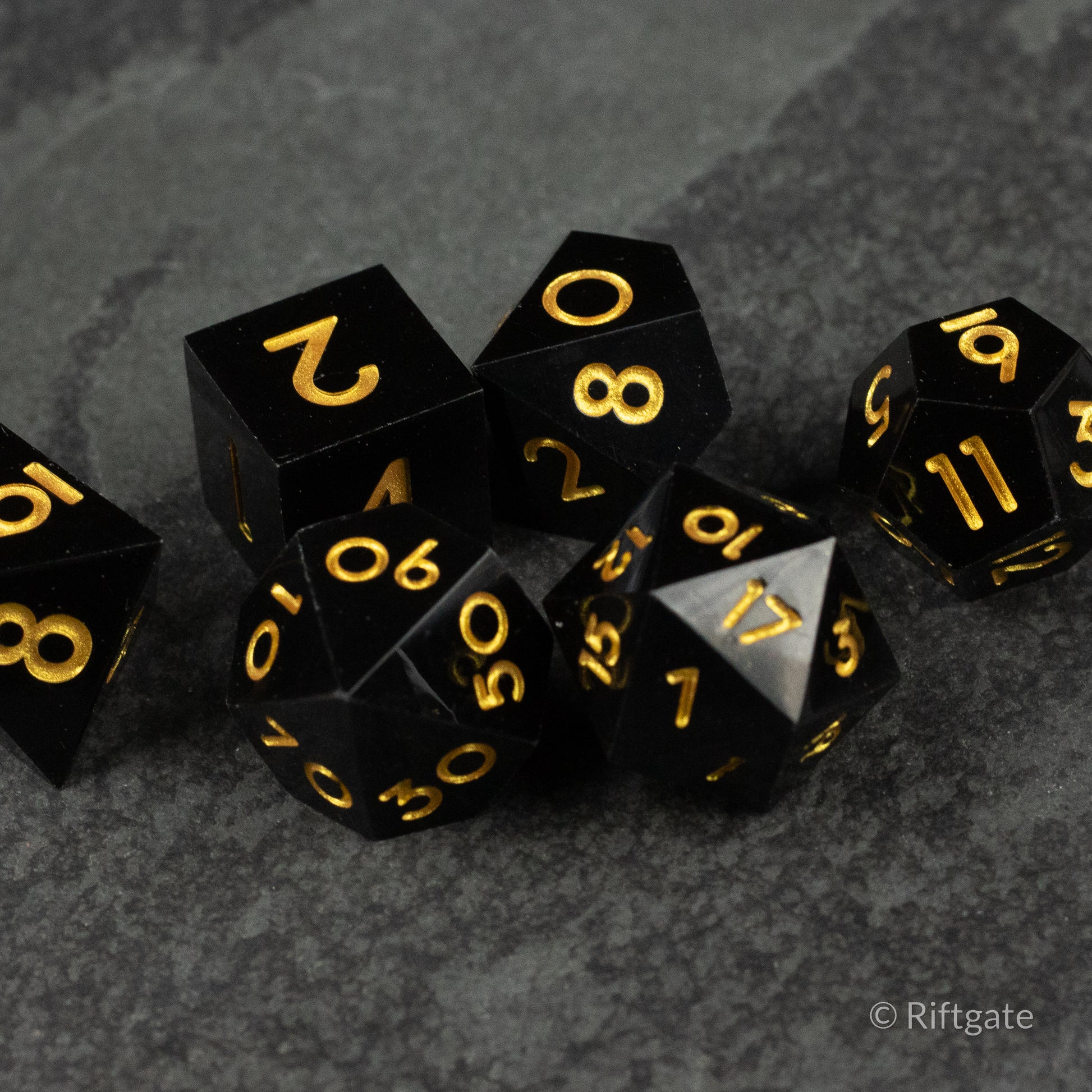 Midnight Sovereign Dice Set - Black sharp-edged polyhedral dice set with gold numbering, including d20, d12, d10, d8, d6, and d4.