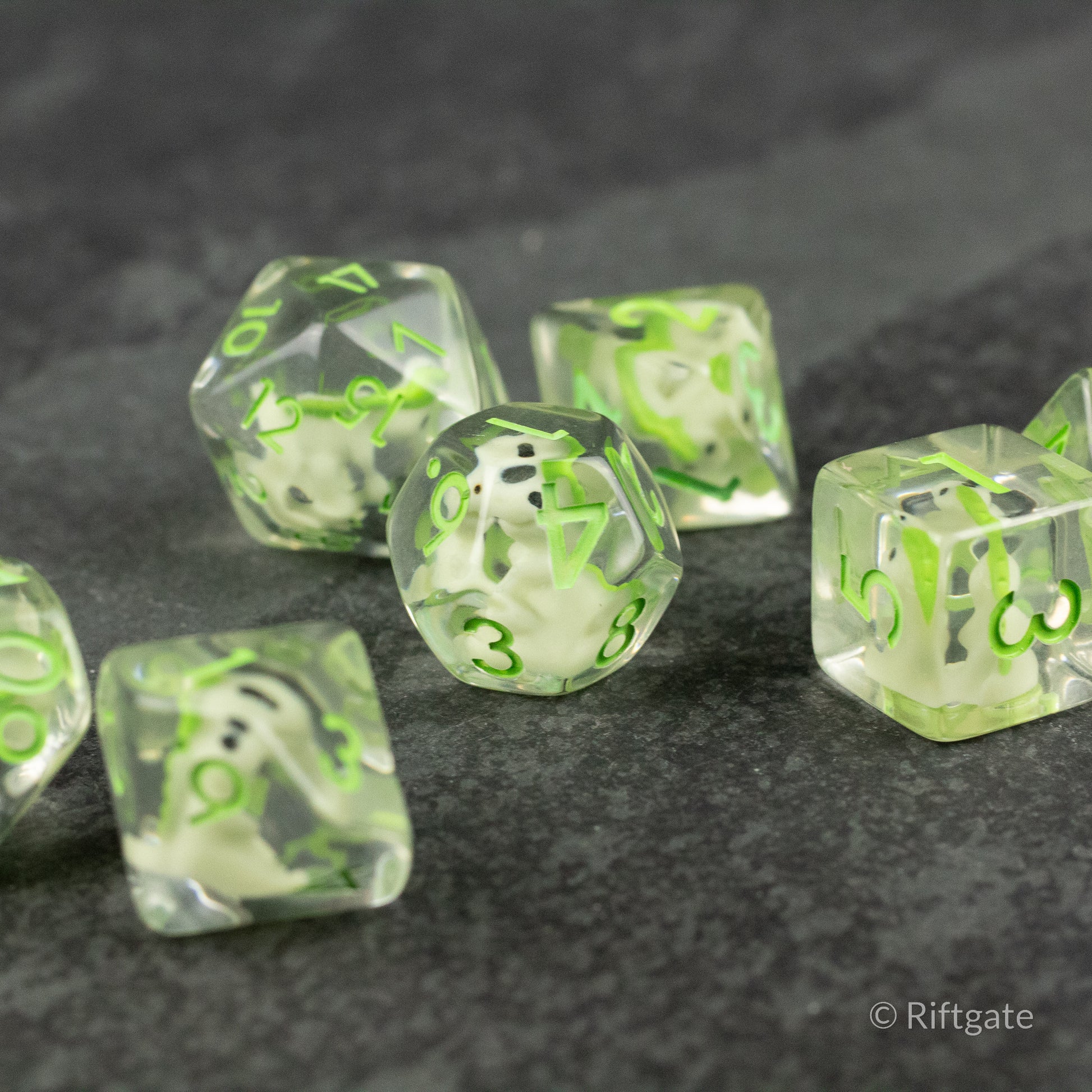 Green T-Rex Dice Set - Translucent green polyhedral dice set with neon green numbers, including d20, d12, d10, d8, d6, and d4.