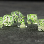 Green T-Rex Dice Set - Set of transparent green polyhedral dice with bright green numbers and a small T-Rex figure inside the clear d6 die.