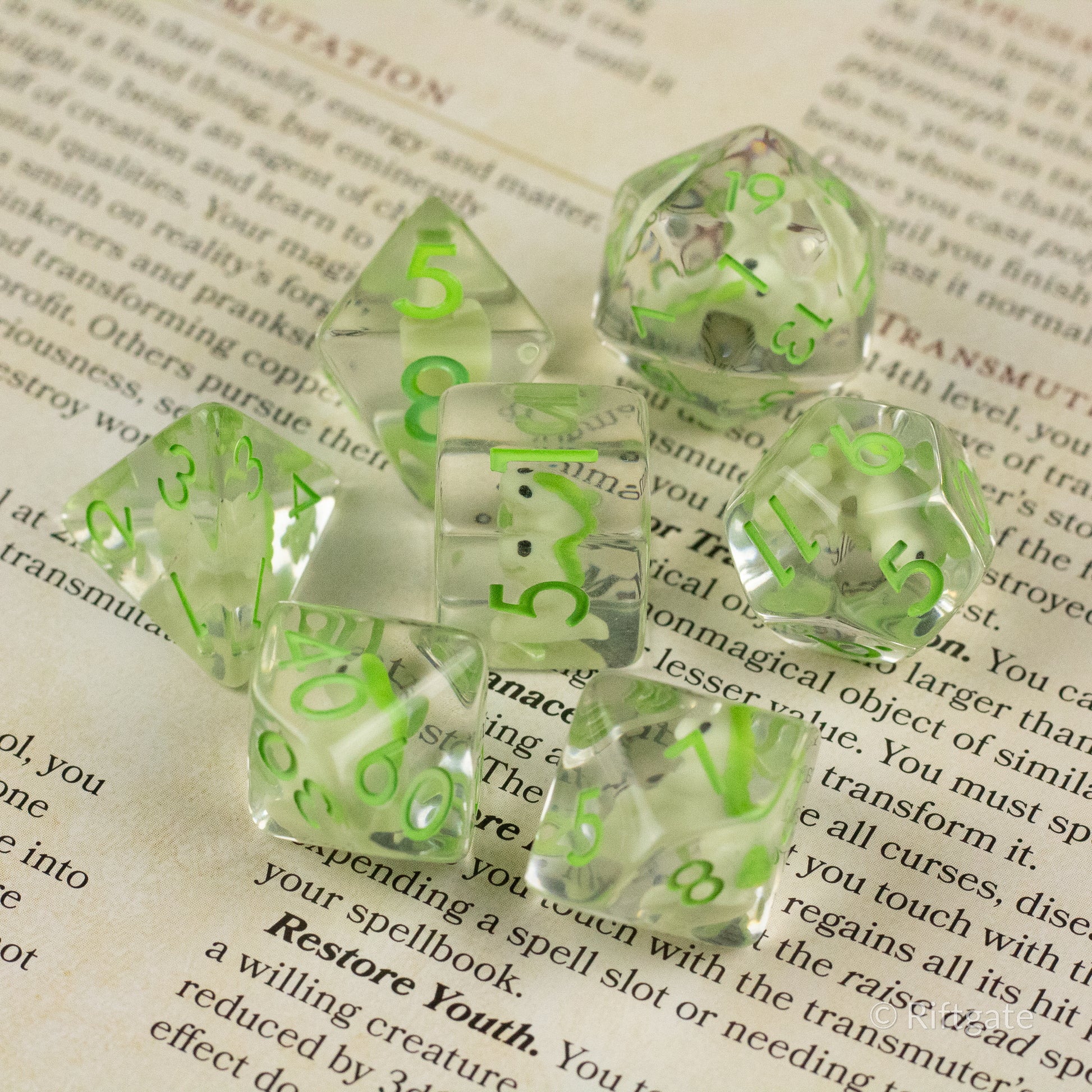 Green T-Rex Dice Set - Translucent clear dice set with neon green numbers and dinosaur silhouettes, featuring standard polyhedral shapes for.