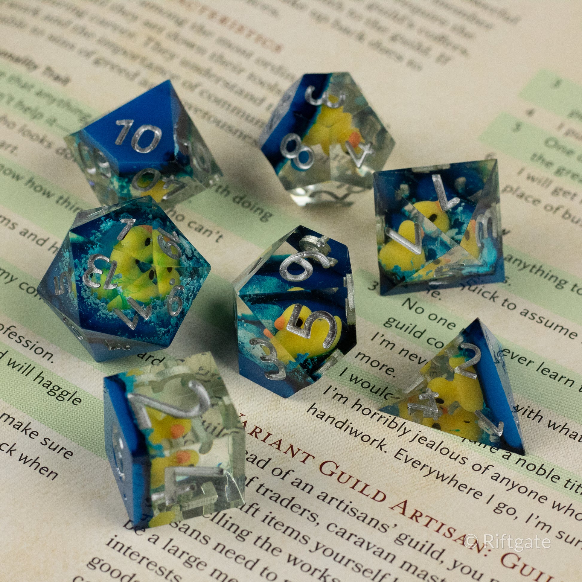 Rubber Duck Sharp Edge Dice - Set of six blue translucent sharp-edged dice with embedded yellow rubber duck shapes and white numbering.