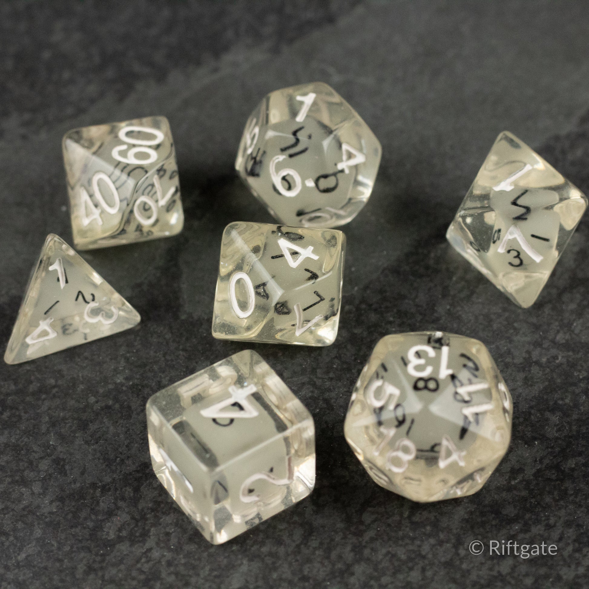 Dice in Dice Dice Set - Transparent polyhedral dice set with smaller dice inside, white numbering on clear material.