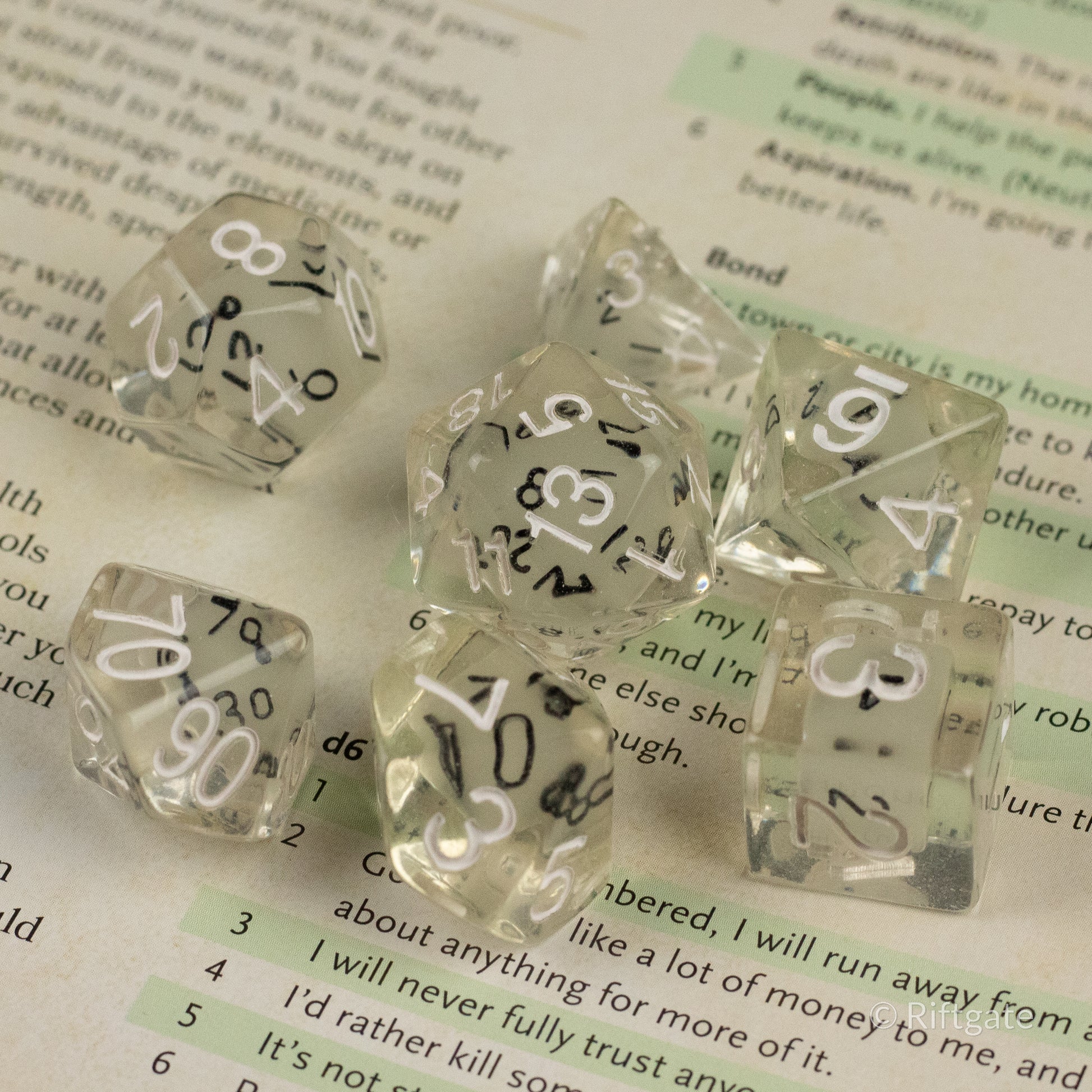 Dice in Dice Dice Set - Set of clear polyhedral dice with smaller black dice inside, white numbers on outer dice.