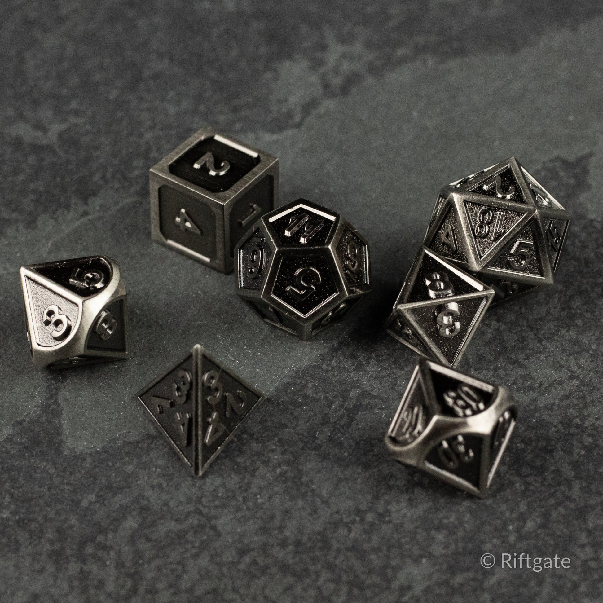 Shadowsteel Dice Set - Metallic dark gray polyhedral dice set with sharp edges and engraved numbers.