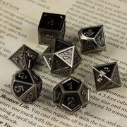 Shadowsteel Dice Set - Shadowsteel metal dice set with dark gray finish, featuring seven polyhedral shapes with engraved numbers.
