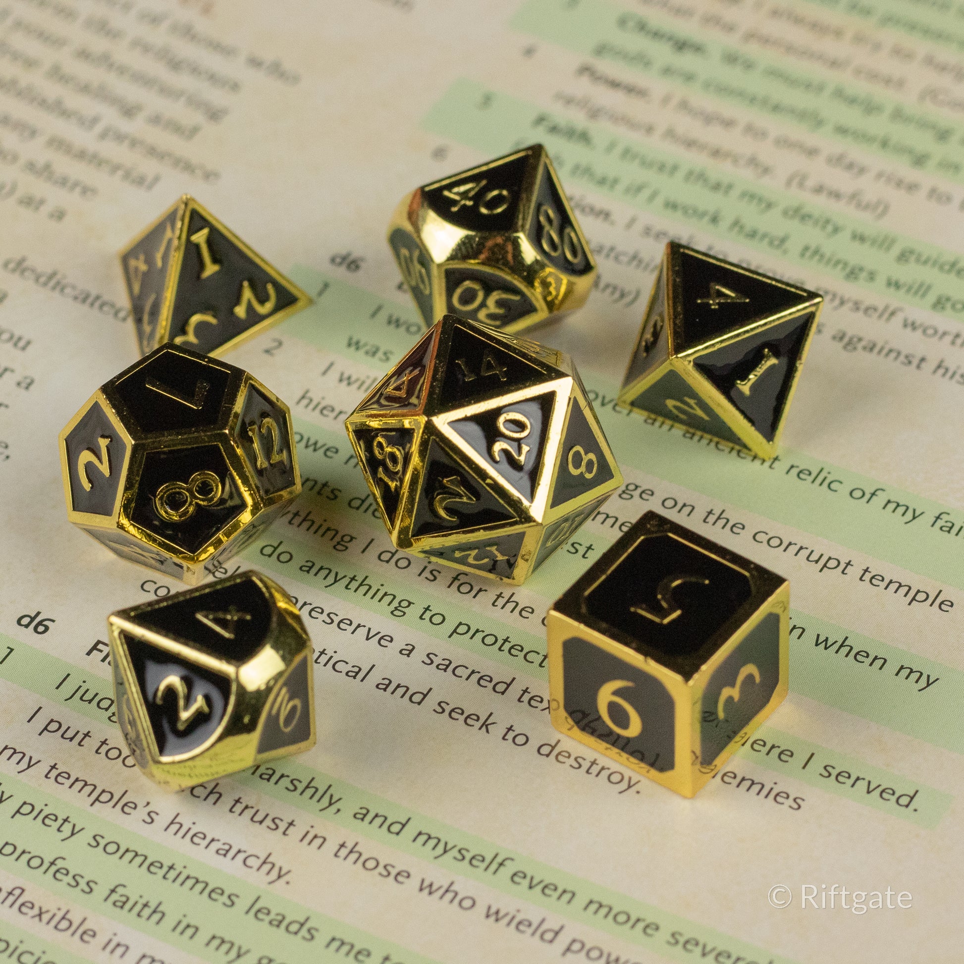 Aurum Eclipse Dice Set - Gold and black metal polyhedral dice set with engraved numbers and symbols for tabletop games.