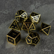 Aurum Eclipse Dice Set - Seven-piece metal dice set in black finish with gold edges and engraved numbers, including d4, d6, d8, d10, d12, and d20.