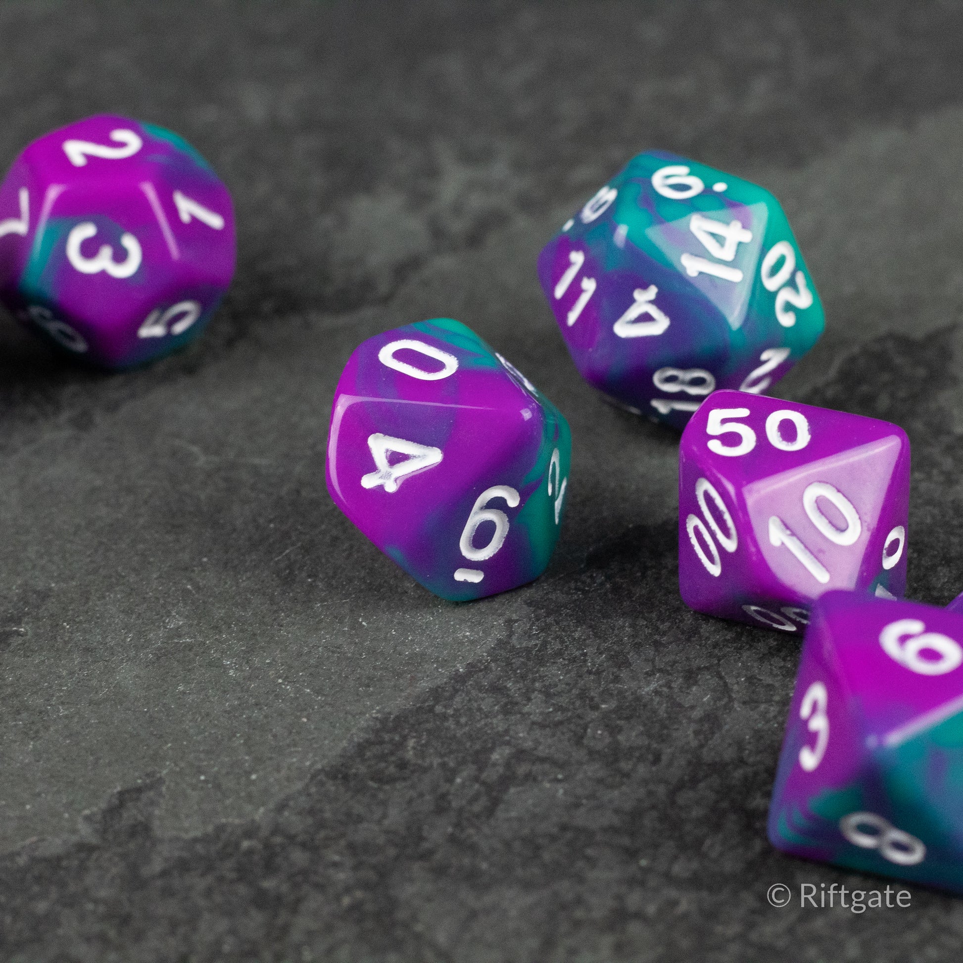 Purple and Turquoise Marbled Dice Set - Set of multifaceted gaming dice with a marbled purple and turquoise pattern and white numbers.