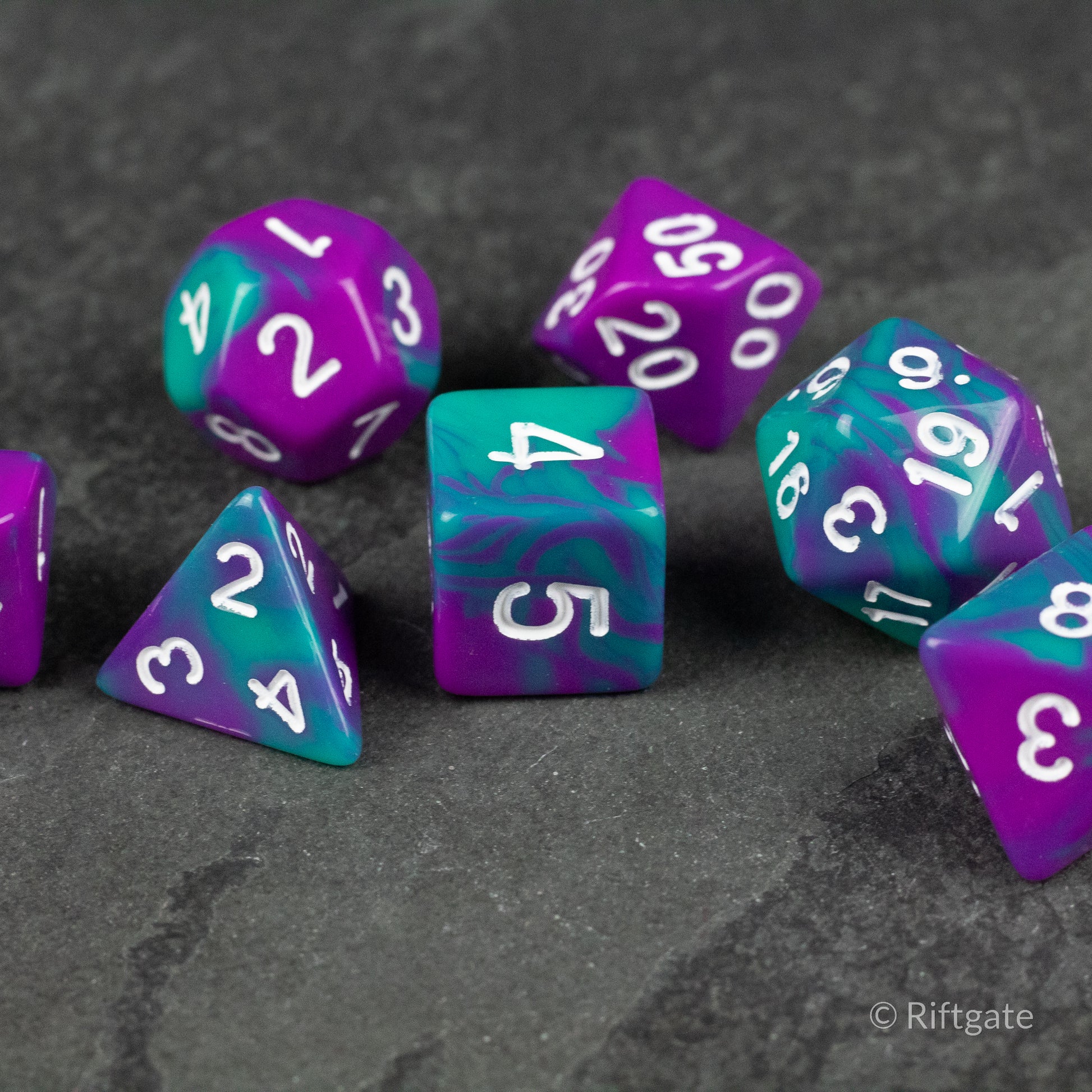 Purple and Turquoise Marbled Dice Set - Purple and turquoise marbled polyhedral dice set with white numbering on a dark surface.