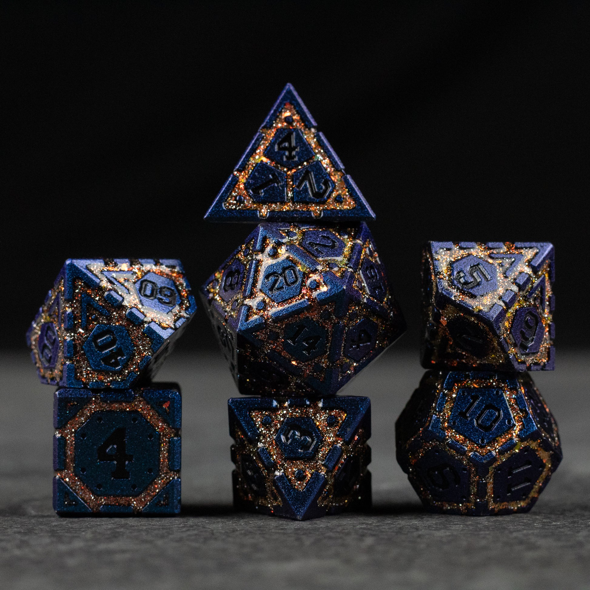 Gold Superior Ward Metal Dice Set - Metallic blue and gold polyhedral dice set with ornate geometric designs and engraved numbers.