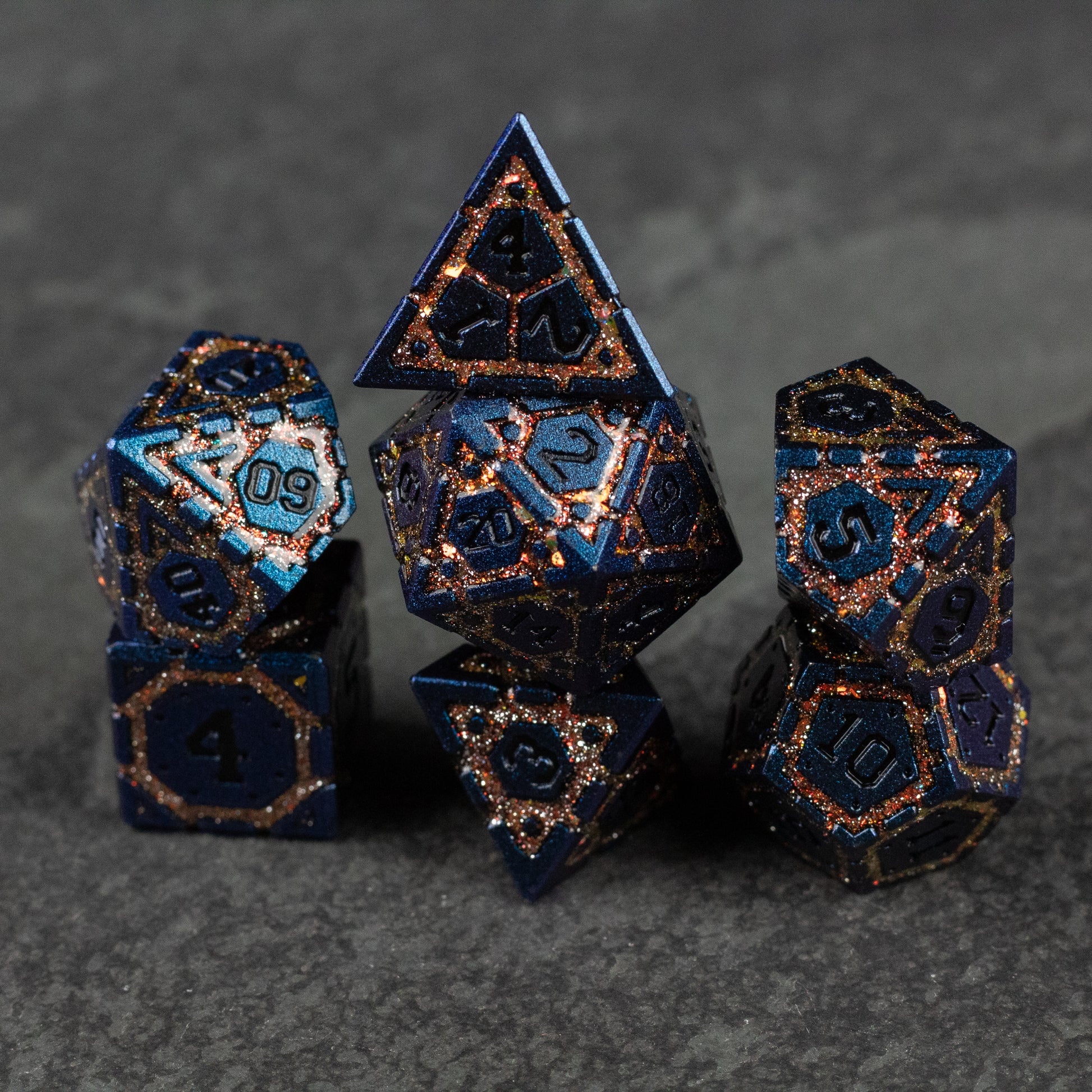 Gold Superior Ward Metal Dice Set - Metallic blue and gold polyhedral dice set with intricate engraved numbers and geometric patterns.