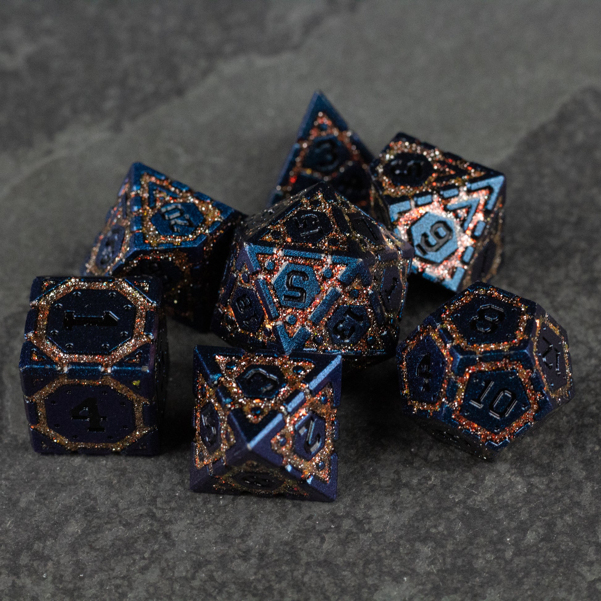 Gold Superior Ward Metal Dice Set - Metal dice set with gold speckled dark blue finish and bright blue numbers, various polyhedral shapes.