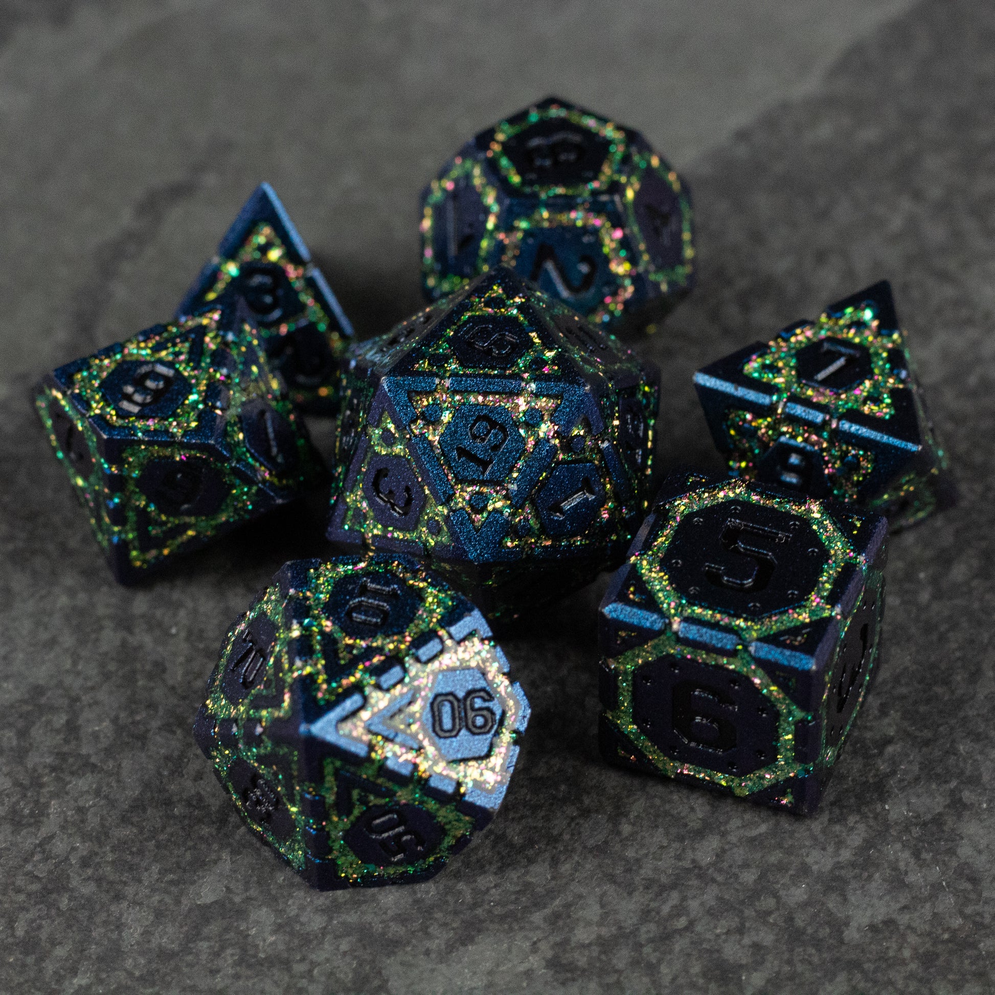 Green Superior Ward Metal Dice Set - Metallic green polyhedral dice set with sharp edges and intricate black and blue detailing.
