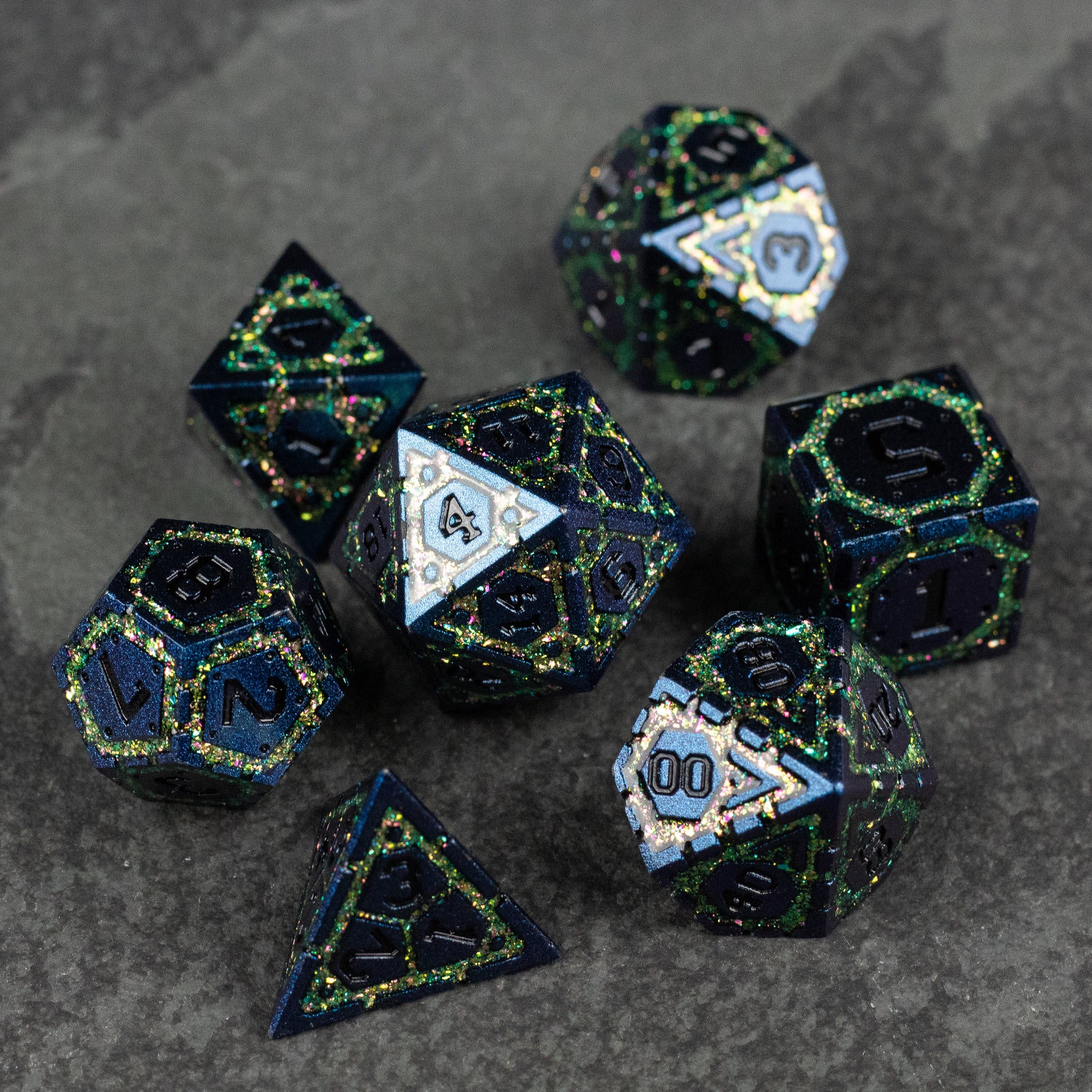 Green Superior Ward Metal Dice Set - Glossy dark green metal dice set with intricate gold and blue speckled patterns, including polyhedral shapes.
