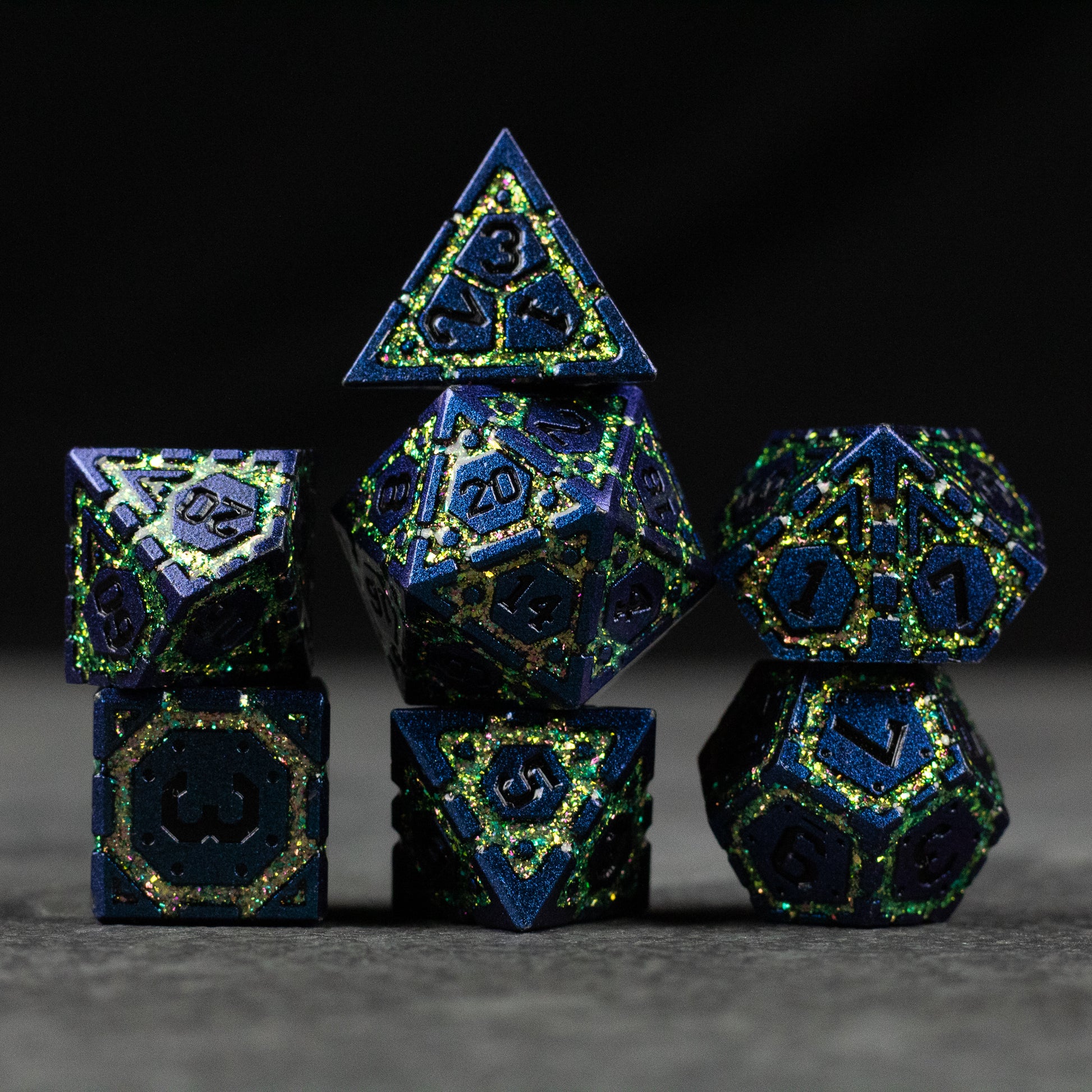 Green Superior Ward Metal Dice Set - Green and blue metal polyhedral dice set with gold numbering and intricate recessed patterns.