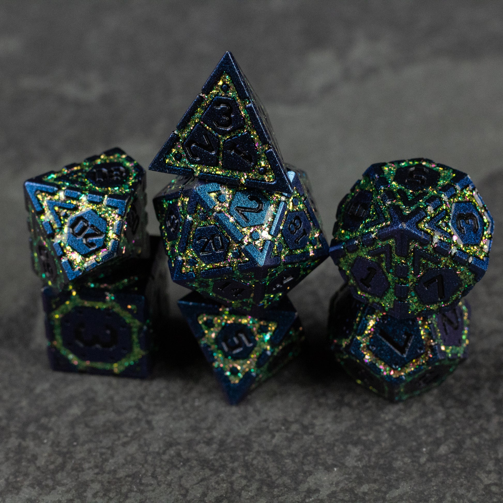 Green Superior Ward Metal Dice Set - Set of seven dark green metal polyhedral dice with gold etched numbers and intricate geometric patterns.