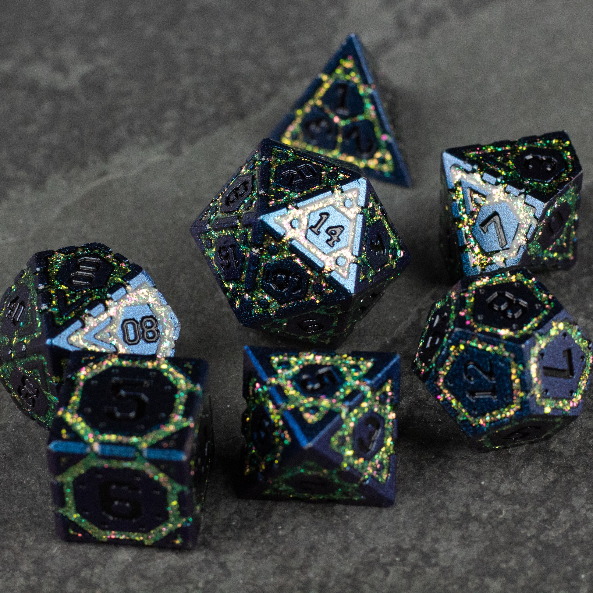 Green Superior Ward Metal Dice Set - Set of seven green and black metal polyhedral dice with gold and light blue numbering and detailing.