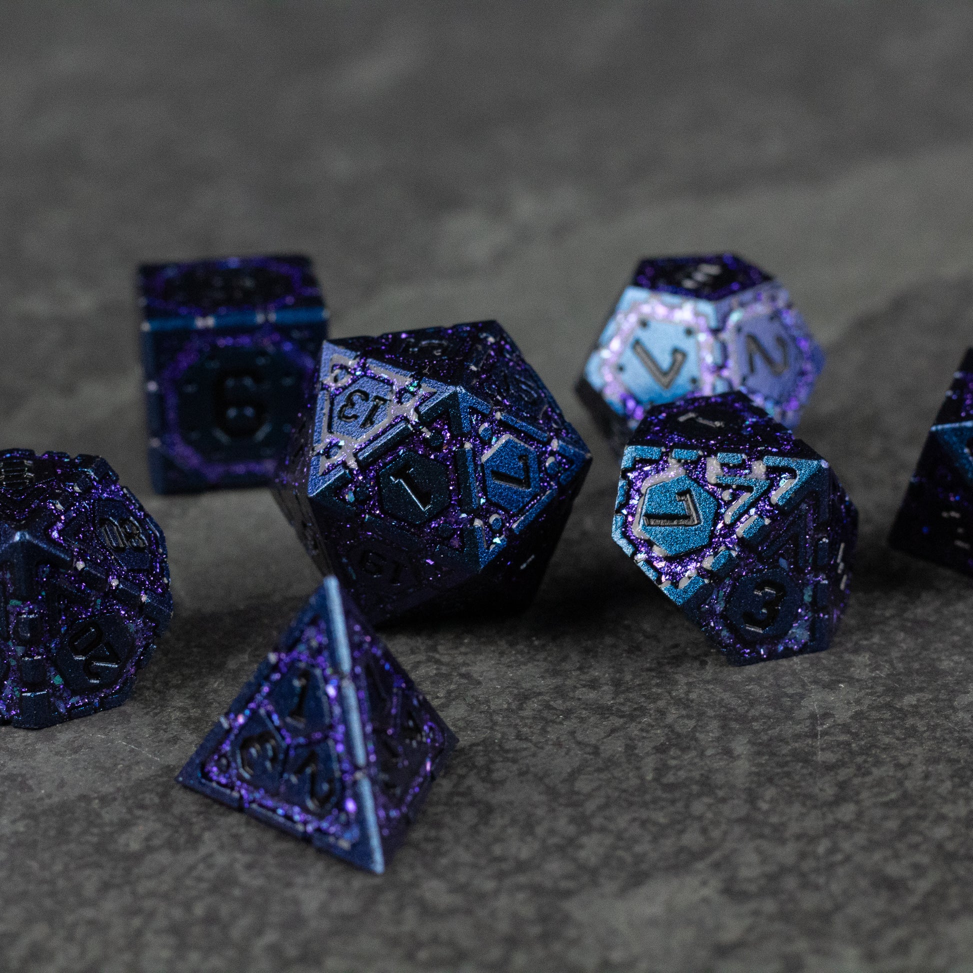 Purple Superior Ward Metal Dice Set - Glossy purple metal polyhedral dice set with engraved light blue numbers, featuring a d4, d6, d8, d10, d12, and d20 on a.