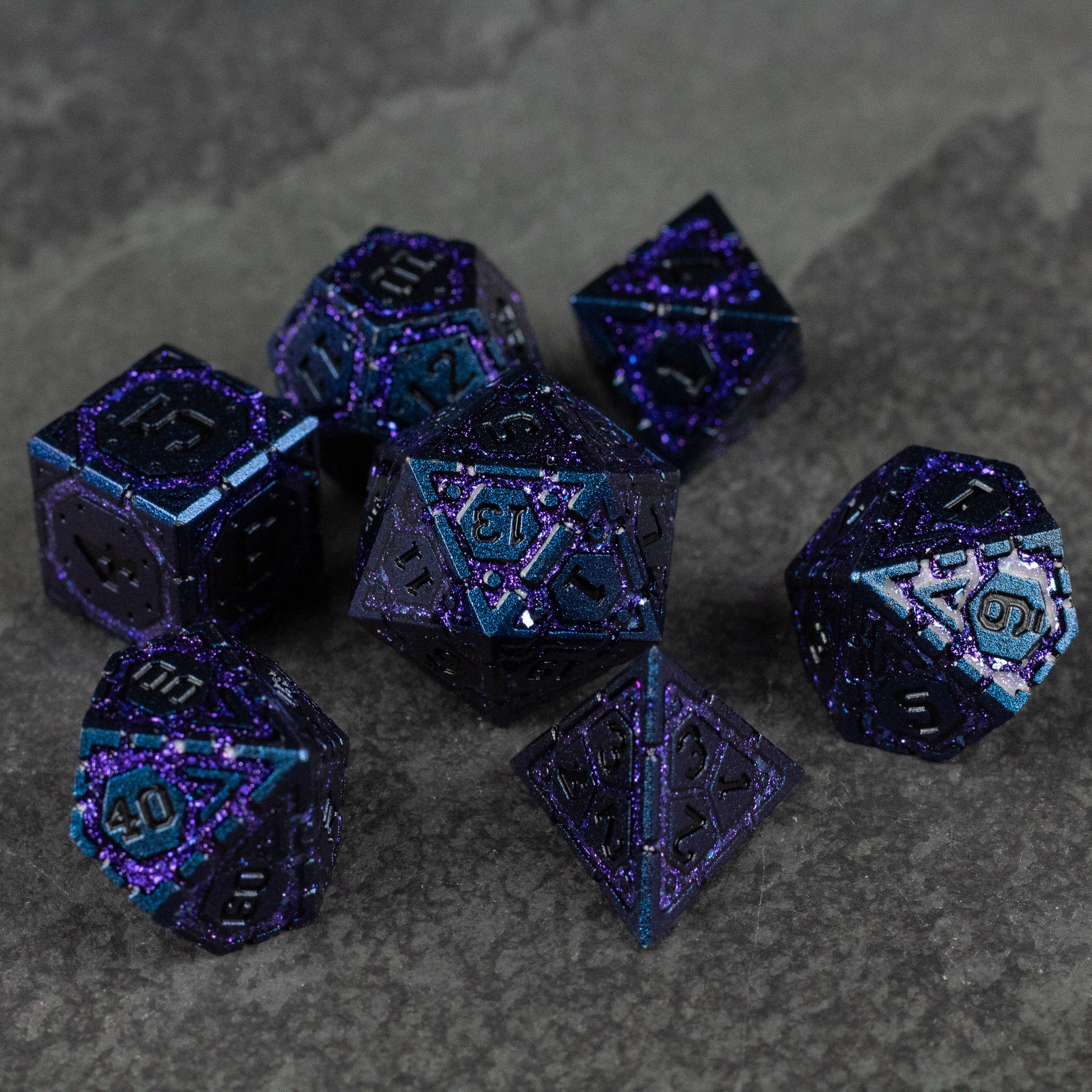 Purple Superior Ward Metal Dice Set - Set of seven deep purple metallic polyhedral dice with shimmering blue speckles and engraved white numbers.