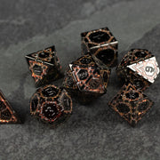 Gold Arcane Ward Metal Dice Set - Black and gold metal polyhedral dice set with intricate arcane-inspired designs.